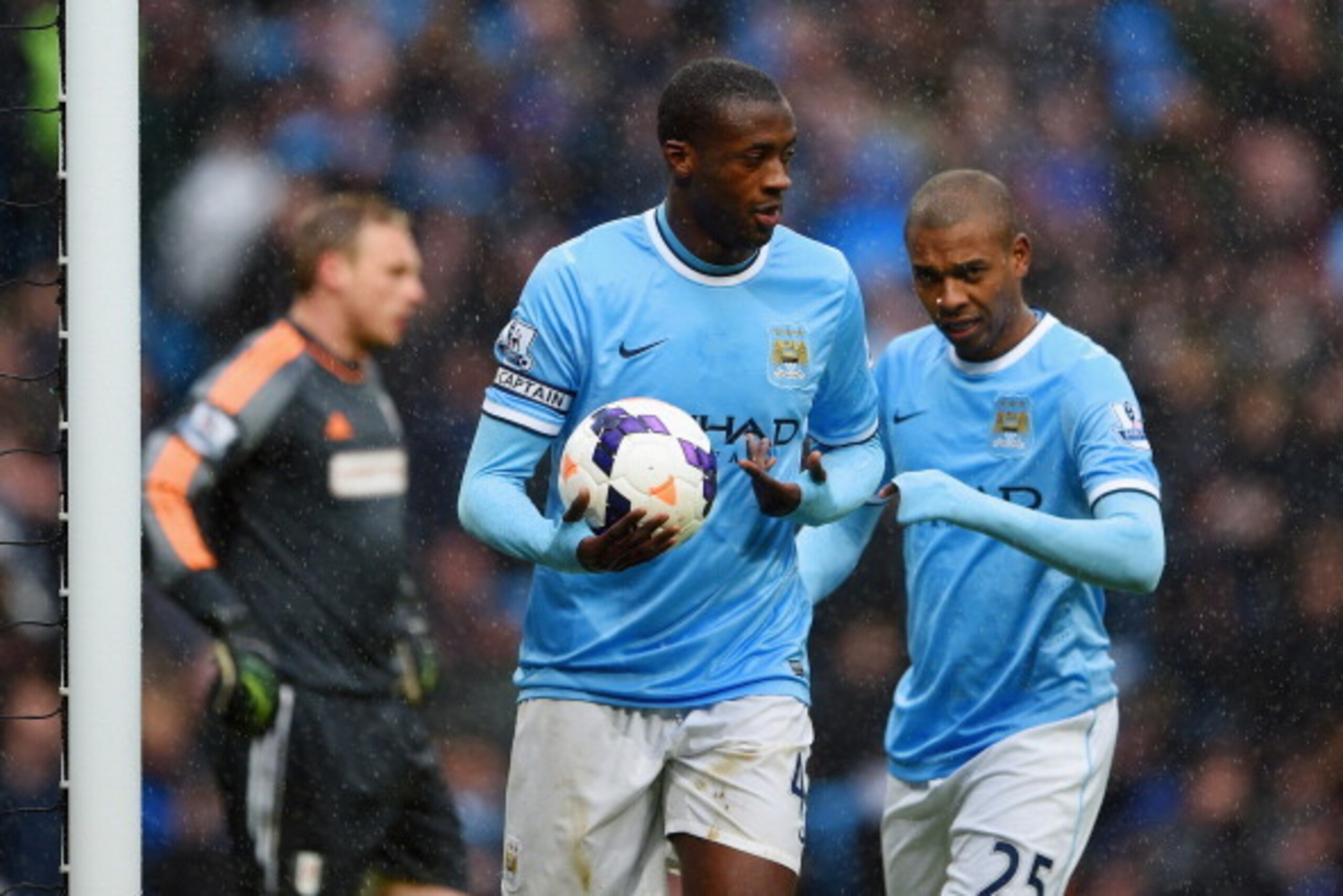 MANCHESTER, ENGLAND - MARCH 22:  Yaya Toure of Manchester City celebrates scoring their second goal with Fernandinho of Manchester City during the Barclays Premier League match between Manchester City and Fulham at Etihad Stadium on March 22, 2014 in Manc