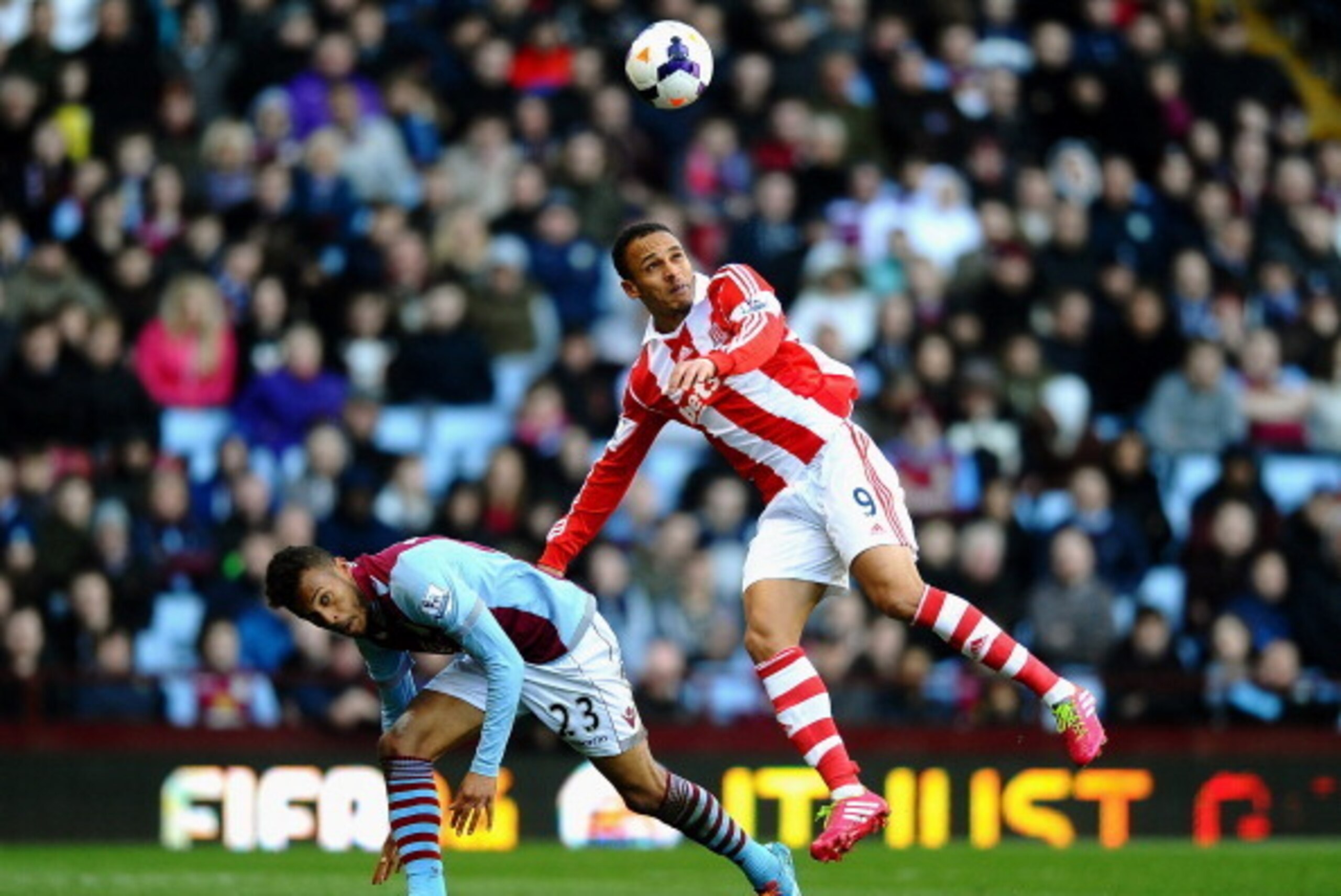 BIRMINGHAM, ENGLAND - MARCH 23:  Peter Odemwingie of Stoke wins a header under pressure from Ryan Bertrand of Aston Villa during the Barclays Premier League match between Aston Villa and Stoke City at Villa Park on March 23, 2014 in Birmingham, England.  
