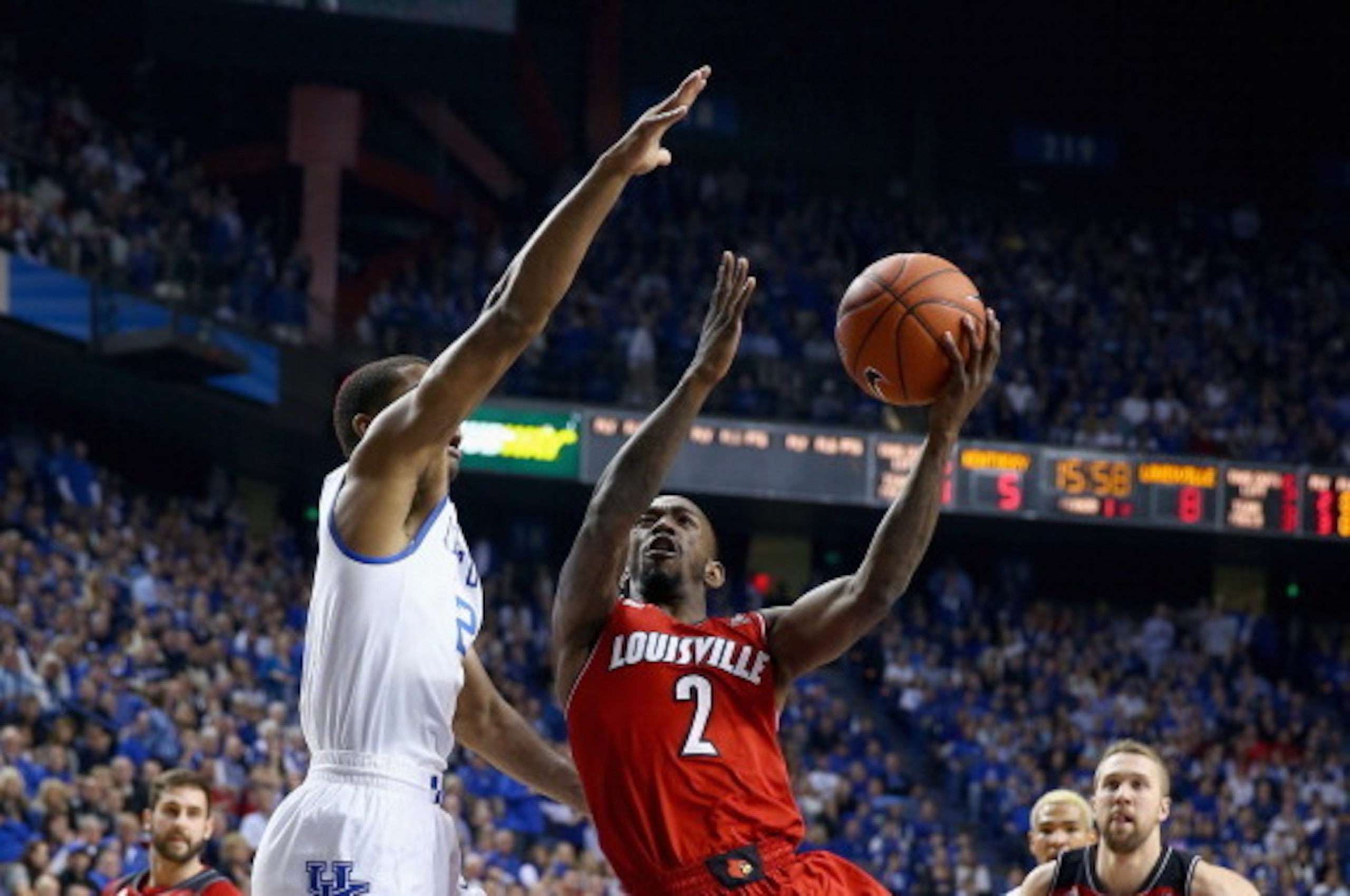 LEXINGTON, KY - DECEMBER 28:  Russ Smith #2 of the Louisville Cardinals shoots the ball while defended by Aaron Harrison #2 of the Kentucky Wildcats during the game at Rupp Arena on December 28, 2013 in Lexington, Kentucky.  (Photo by Andy Lyons/Getty Ima