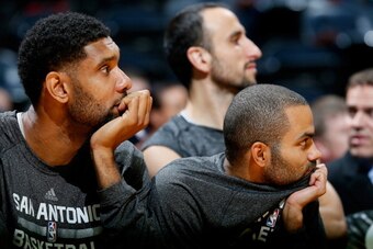 ATLANTA, GA - OCTOBER 17:  Tim Duncan #21 and Tony Parker #9 of the San Antonio Spurs watch in the final seconds during the game against the Atlanta Hawks at Philips Arena on October 17, 2013 in Atlanta, Georgia.  NOTE TO USER: User expressly acknowledges