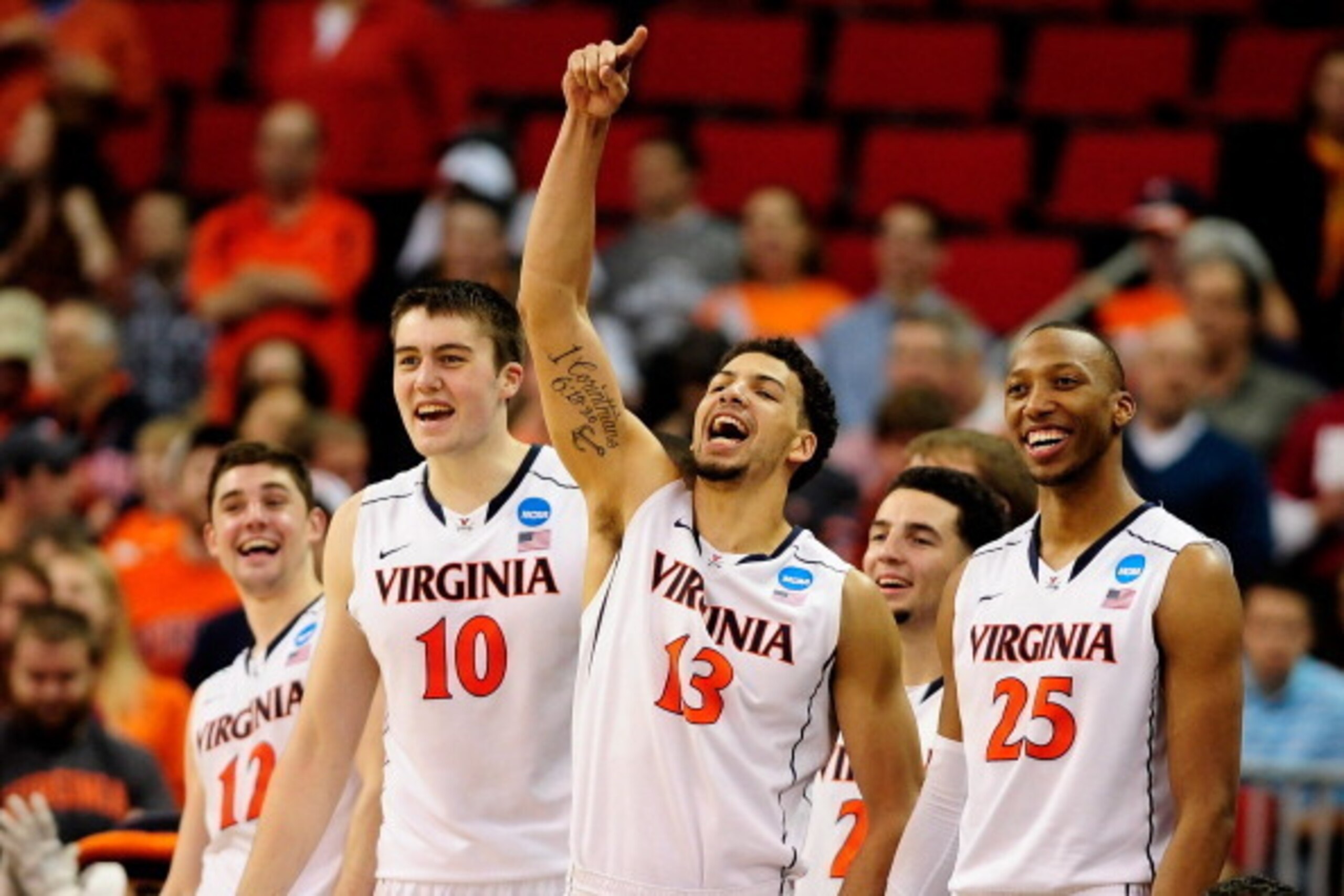 RALEIGH, NC - MARCH 23:  Joe Harris #12, Mike Tobey #10, Anthony Gill #13 and Akil Mitchell #25 of the Virginia Cavaliers react late in the game against the Memphis Tigers during the third round of the 2014 NCAA Men's Basketball Tournament at PNC Arena on