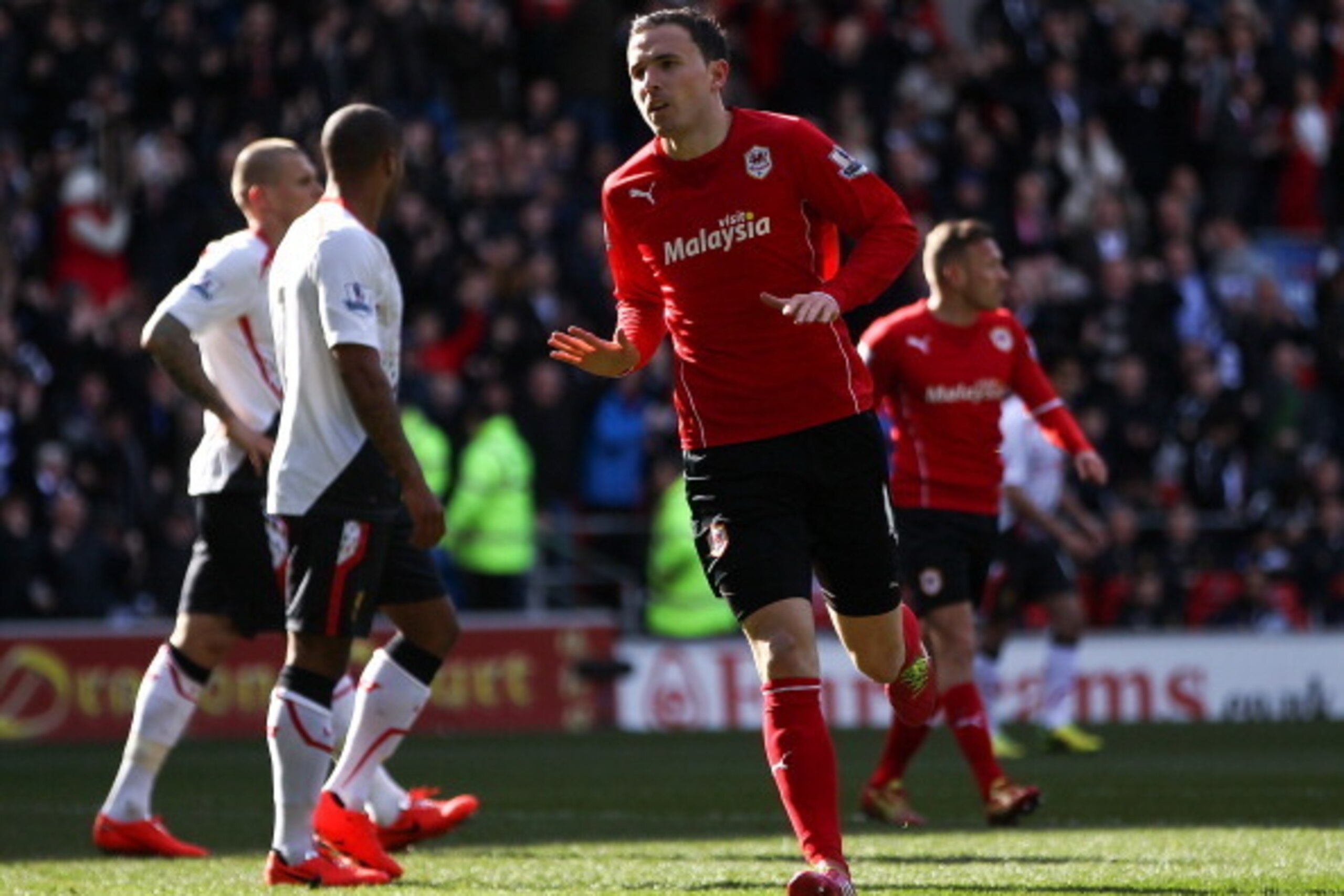 CARDIFF, WALES - MARCH 22:  Jordan Mutch of Cardiff celebrates after scoring the opening goal of the game during the Barclays Premier League match between Cardiff City and Liverpool at Cardiff City Stadium on March 22, 2014 in Cardiff, Wales.  (Photo by B