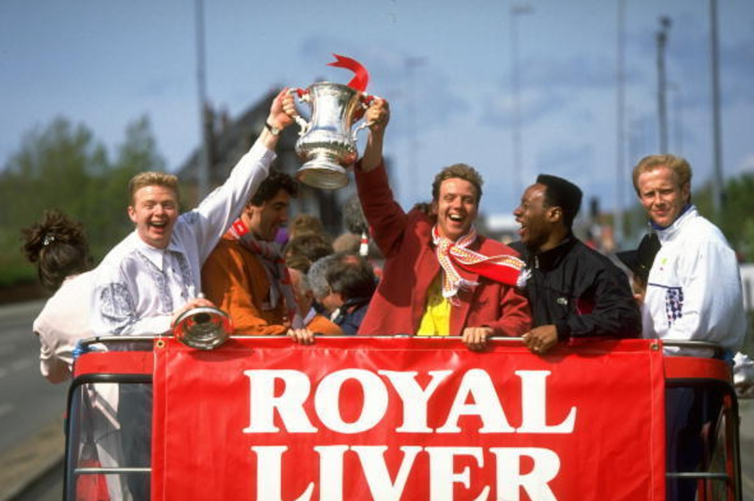 10 May 1992:  (From left to right) David Burrows, Dean Saunders, Rob Jones, Mark Walters and Mark Wright of Liverpool stand on the top deck of the tour bus and celebrate as they hold the trophy aloft during their homecoming after their FA Cup Final victor