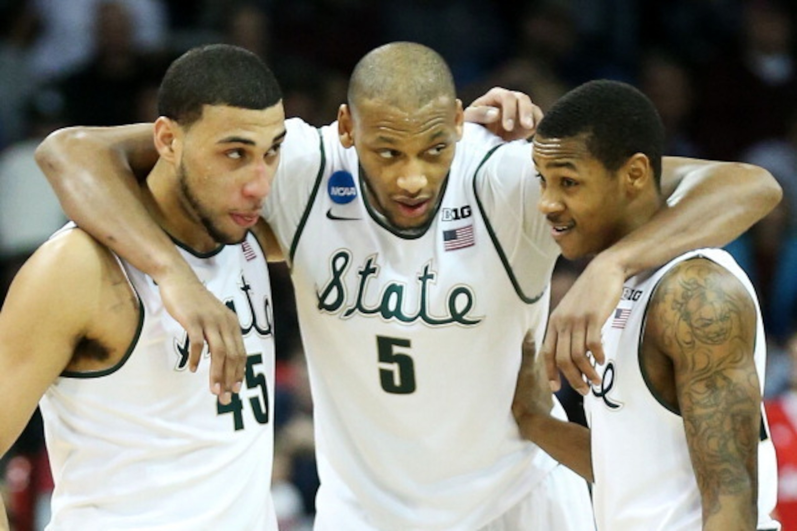 SPOKANE, WA - MARCH 22:  Denzel Valentine #45 Adreian Payne #5 and Keith Appling #11 of the Michigan State Spartans celebrate in the second half of their 80 to 73 win over the Harvard Crimson during the Third Round of the 2014 NCAA Basketball Tournament a