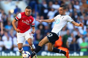 LONDON, ENGLAND - MARCH 16:  Alex Oxlade-Chamberlain of Arsenal evades the tackle of Nabil Bentaleb of Tottenham Hotspur during the Barclays Premier League match between Tottenham Hotspur and Arsenal at White Hart Lane on March 16, 2014 in London, England