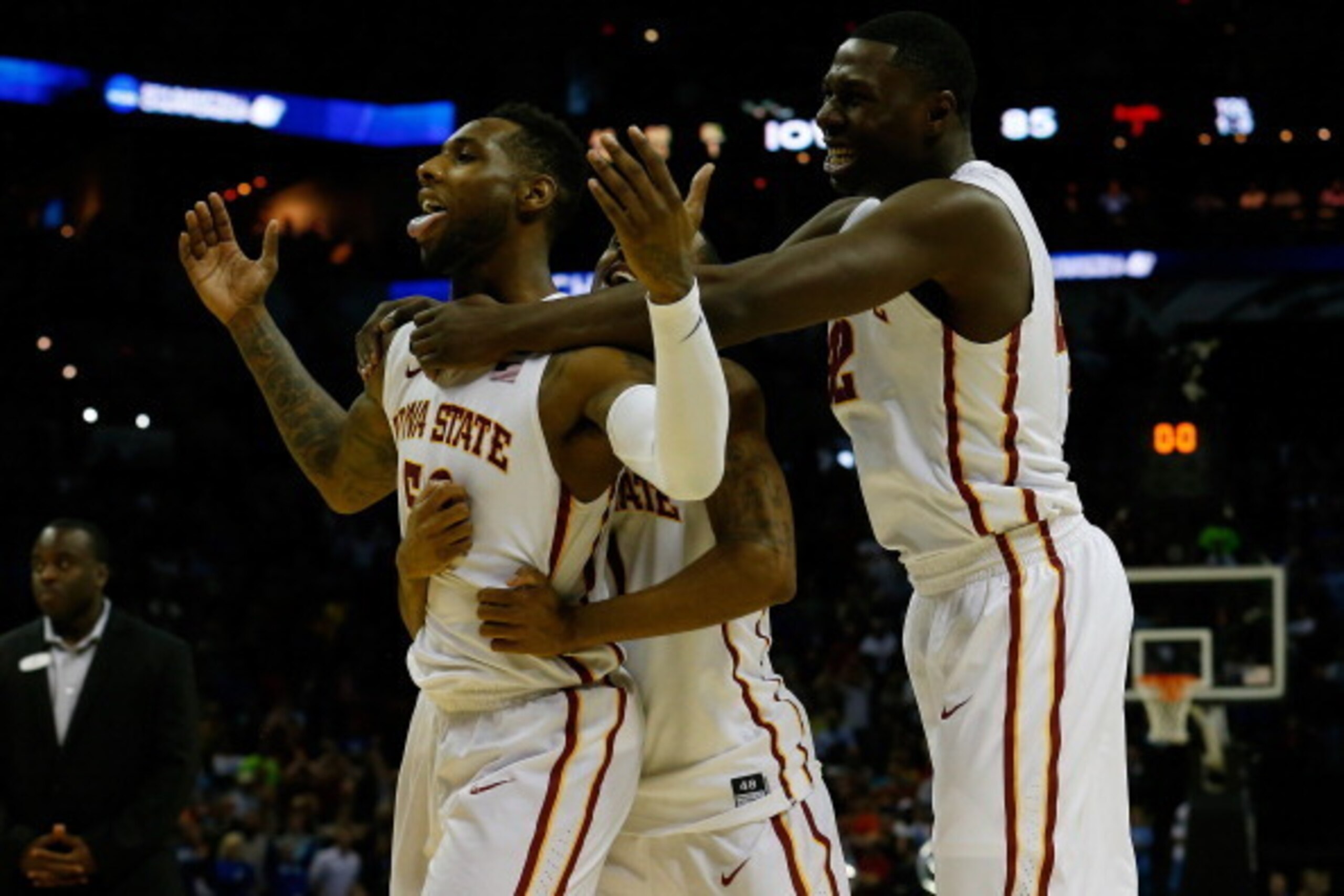 SAN ANTONIO, TX - MARCH 23:  DeAndre Kane #50, Monte Morris #11 and Daniel Edozie #42 of the Iowa State Cyclones celebrate after defeating the North Carolina Tar Heels 85-83 in the third round of the 2014 NCAA Men's Basketball Tournament at the AT&T Cente