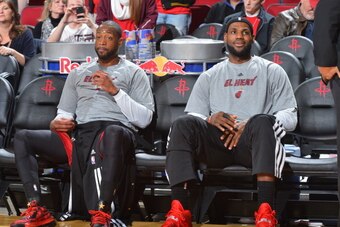 HOUSTON, TX - MARCH 4:  Dwyane Wade #3 and LeBron James #6 of the Miami Heat on the bench before the game against the Houston Rockets at the Toyota Center March 4, 2014 in Houston, Texas. NOTE TO USER: User expressly acknowledges and agrees that, by downl