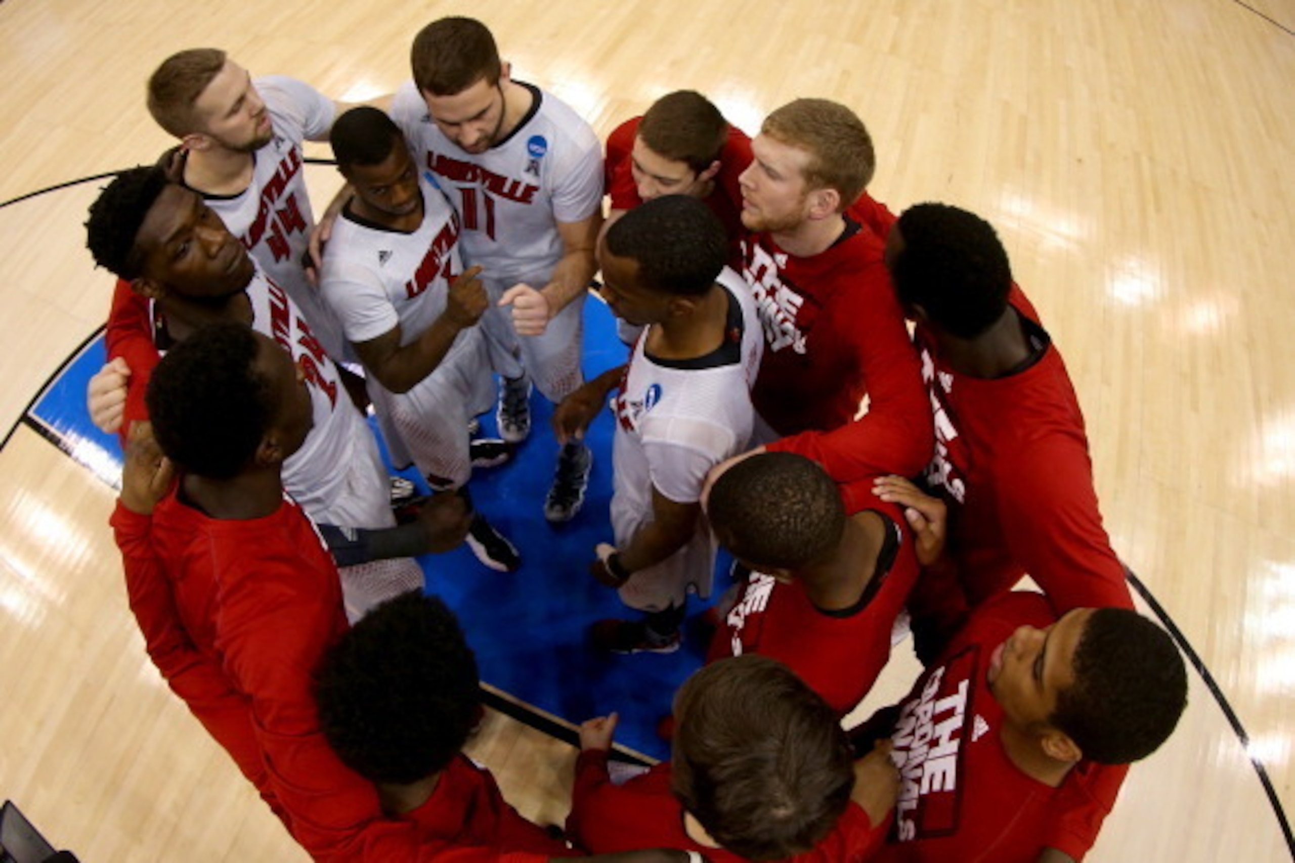 ORLANDO, FL - MARCH 22:  The Louisville Cardinals huddle before taking on the Saint Louis Billikens during the third round of the 2014 NCAA Men's Basketball Tournament at Amway Center on March 22, 2014 in Orlando, Florida.  (Photo by Mike Ehrmann/Getty Im