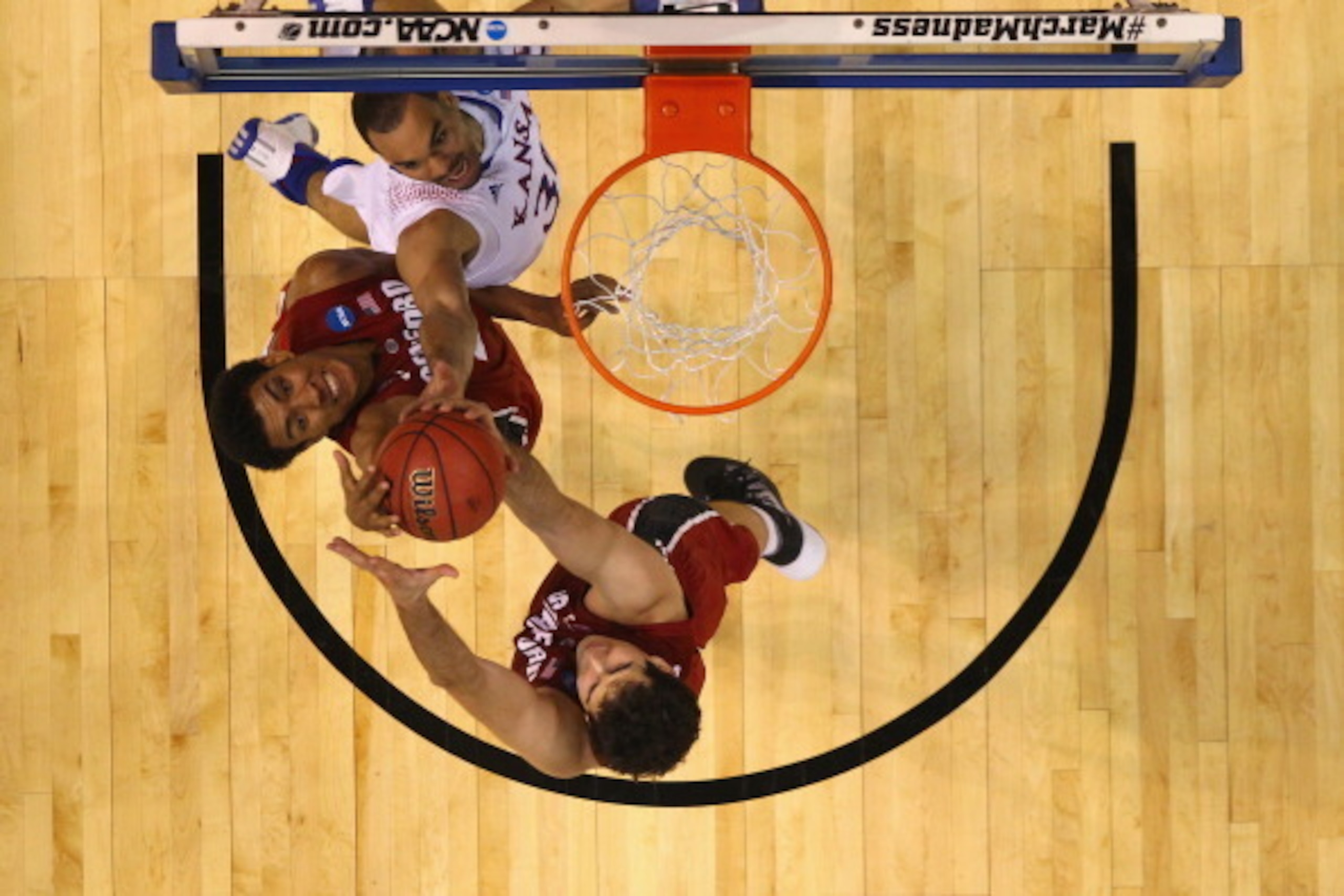 ST LOUIS, MO - MARCH 23:  Josh Huestis #24 of the Stanford Cardinal fights a rebound against Perry Ellis #34 of the Kansas Jayhawks during the third round of the 2014 NCAA Men's Basketball Tournament at Scottrade Center on March 23, 2014 in St Louis, Miss