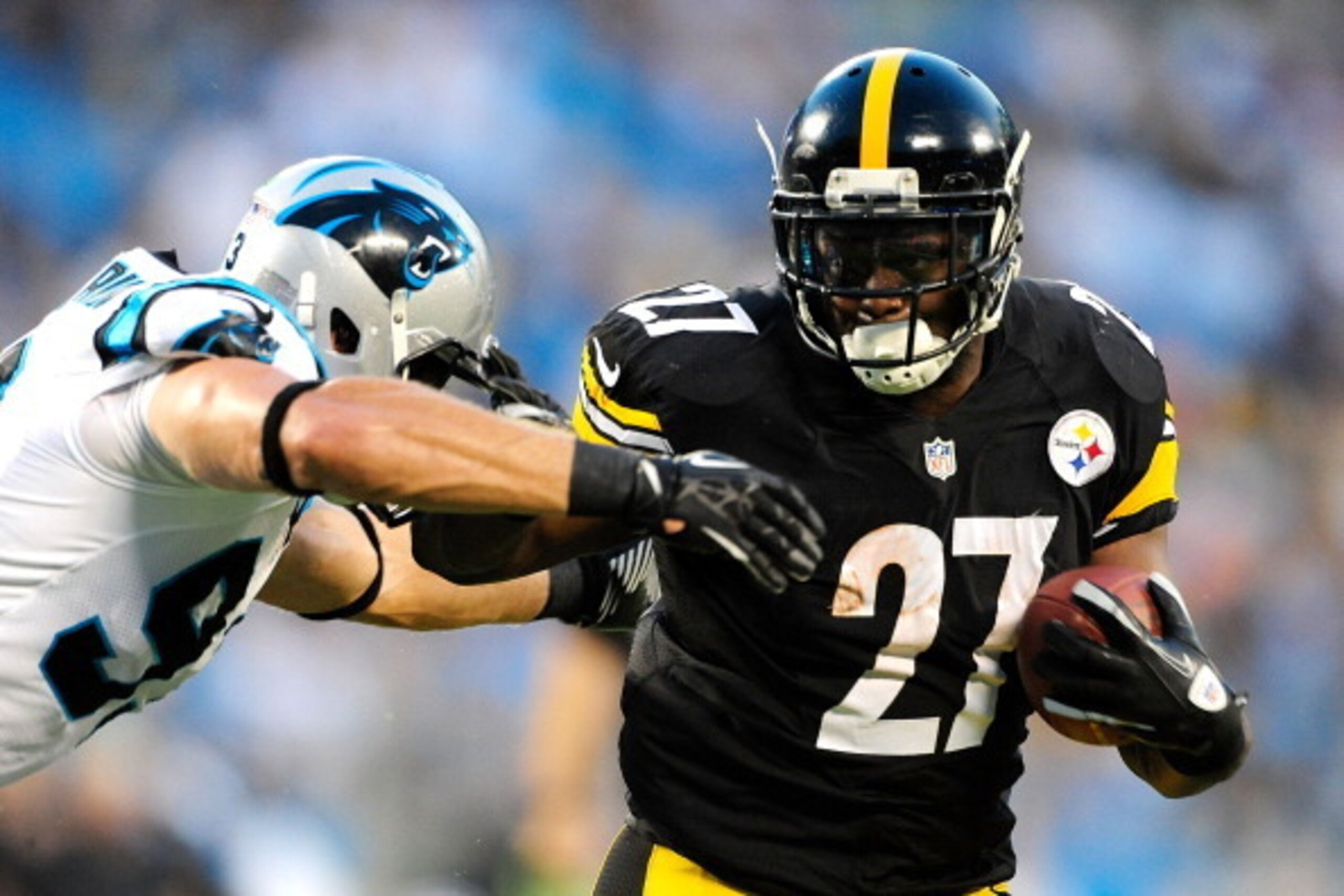 CHARLOTTE, NC - AUGUST 29:  Jonathan Dwyer #27 of the Pittsburgh Steelers stiff-arms Chase Blackburn #93 of the Carolina Panthers during a preseason NFL game at Bank of America Stadium on August 29, 2013 in Charlotte, North Carolina.  (Photo by Grant Halv