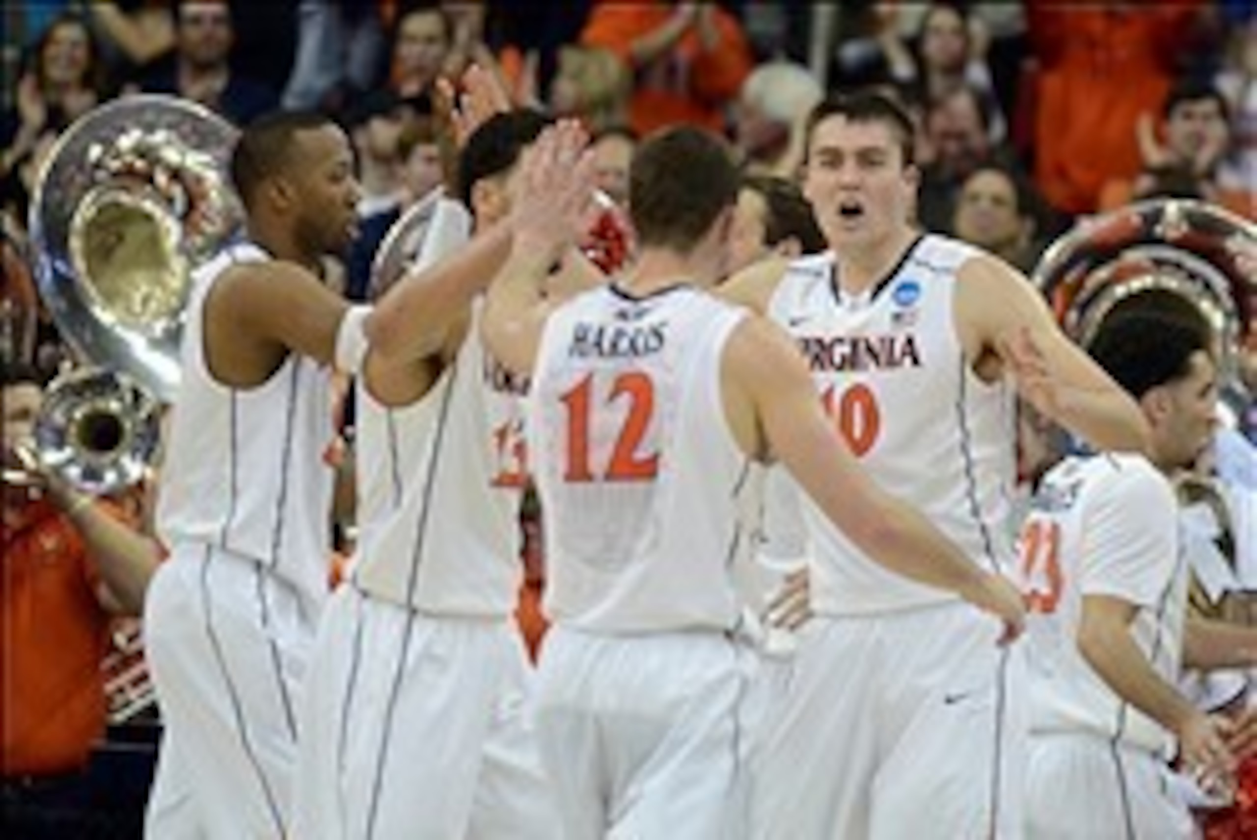 Mar 23, 2014; Raleigh, NC, USA; Virginia Cavaliers forward/center Mike Tobey (10) celebrates with guard Joe Harris (12) against the Memphis Tigers during the first half of a men's college basketball game during the third round of the 2014 NCAA Tournament 