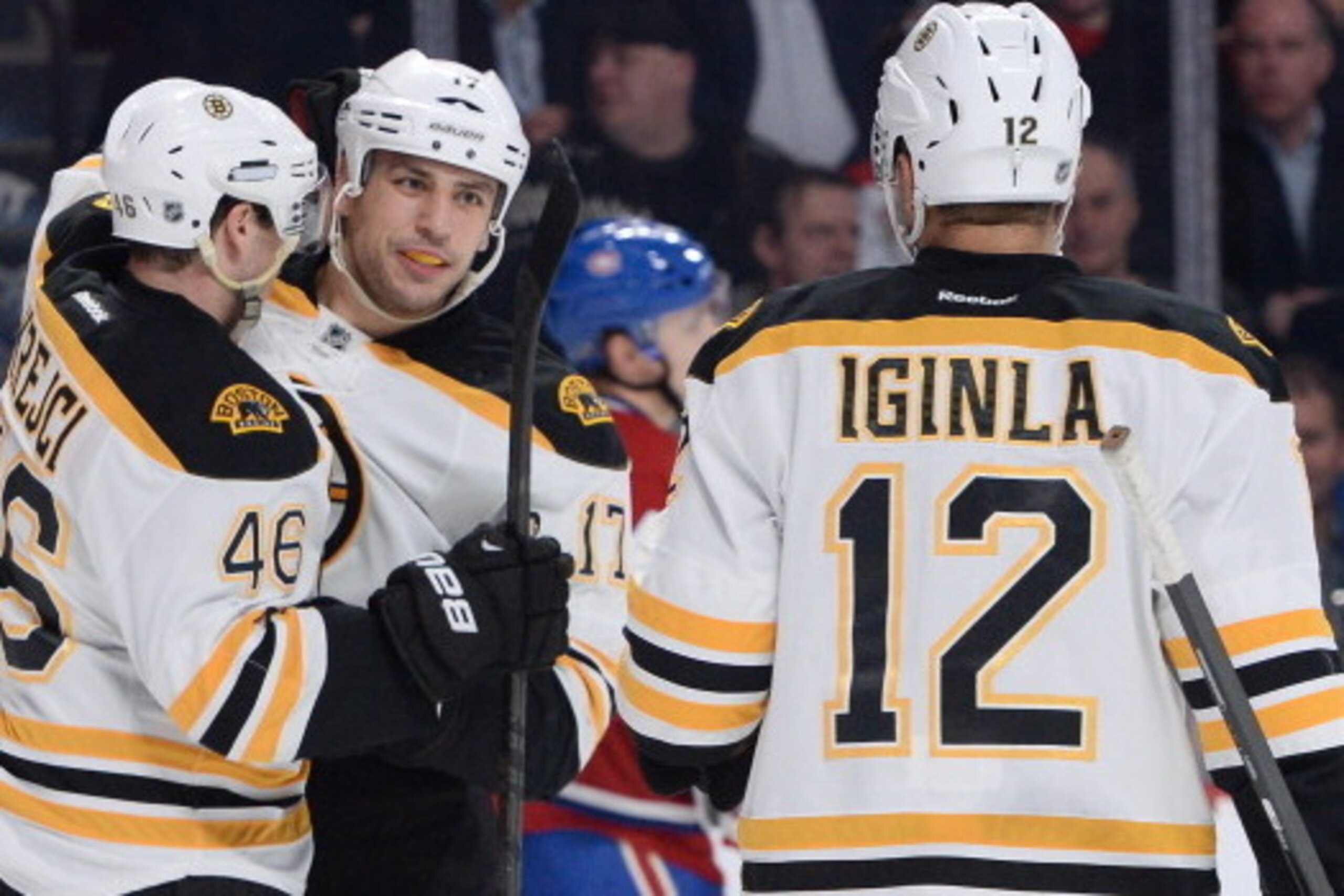 MONTREAL, QC - MARCH 12: Milan Lucic #17 of the Boston Bruins celebrates after scoring a goal against the Montreal Canadiens with teammates David Krejci #46 and Jarome Iginla #12 during the NHL game on March 12, 2014 at the Bell Centre in Montreal, Quebec