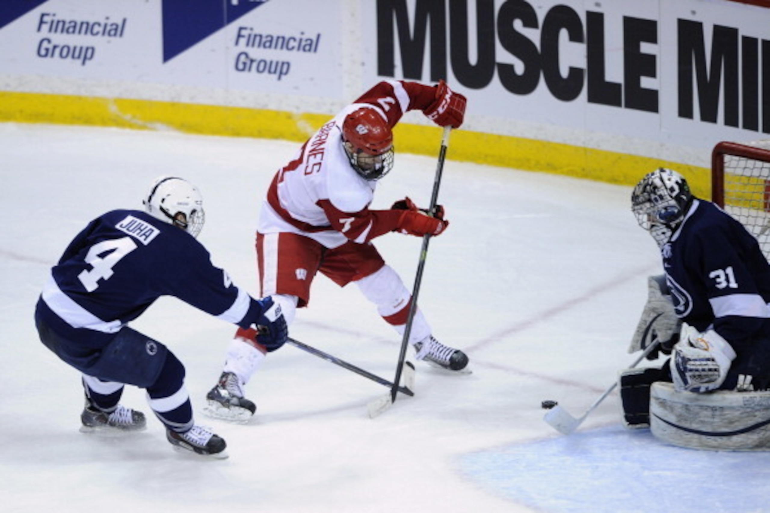 ST PAUL, MN - MARCH 21: Matthew Skoff #31 of the Penn State Nittany Lions blocks a shot by Tyler Barnes #7 of the Wisconsin Badgers as Luke Juha #4 of the Penn State Nittany Lions looks on during the third period of the semifinal game of the Big Ten Men's