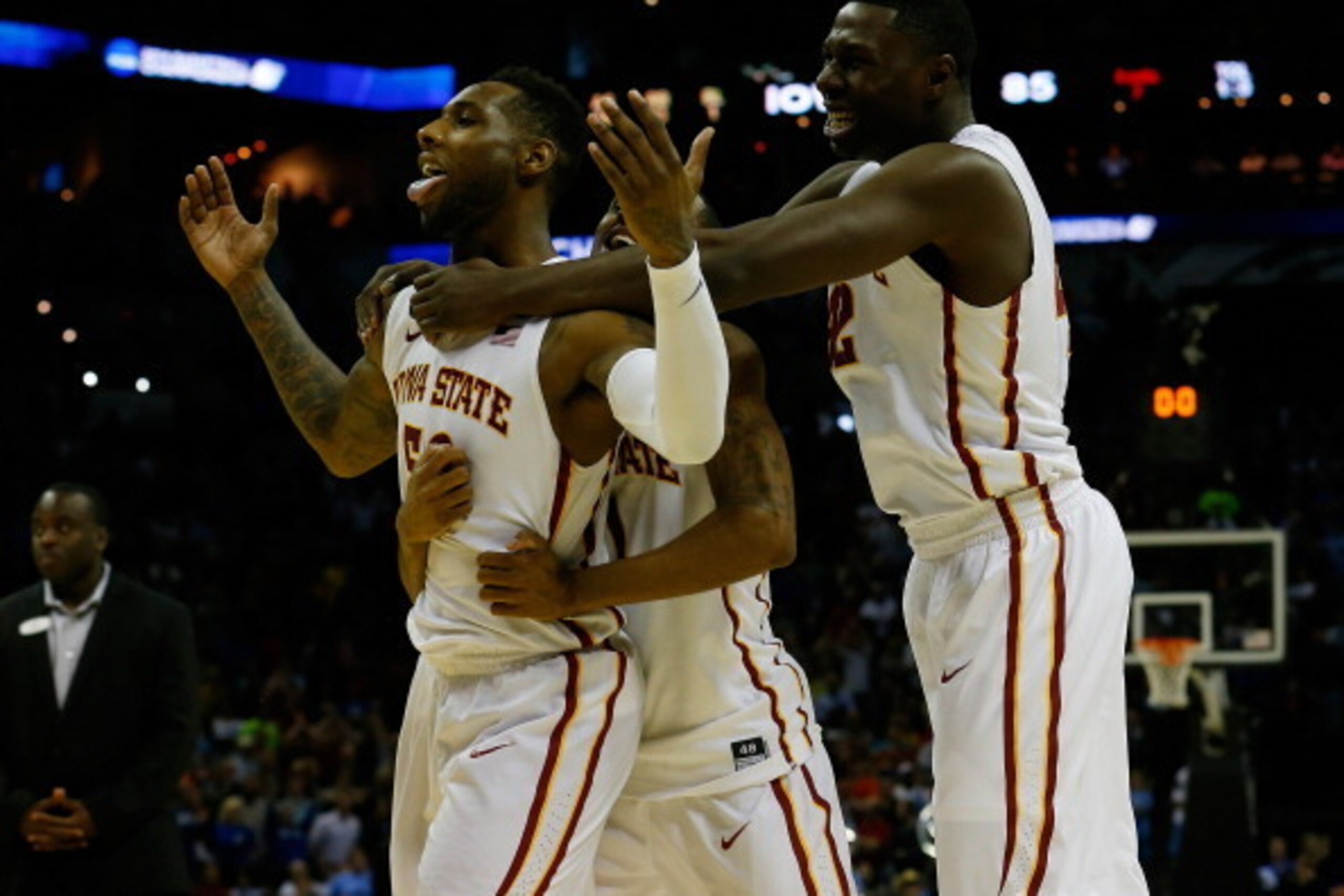 SAN ANTONIO, TX - MARCH 23:  DeAndre Kane #50, Monte Morris #11 and Daniel Edozie #42 of the Iowa State Cyclones celebrate after defeating the North Carolina Tar Heels 85-83 in the third round of the 2014 NCAA Men's Basketball Tournament at the AT&T Cente