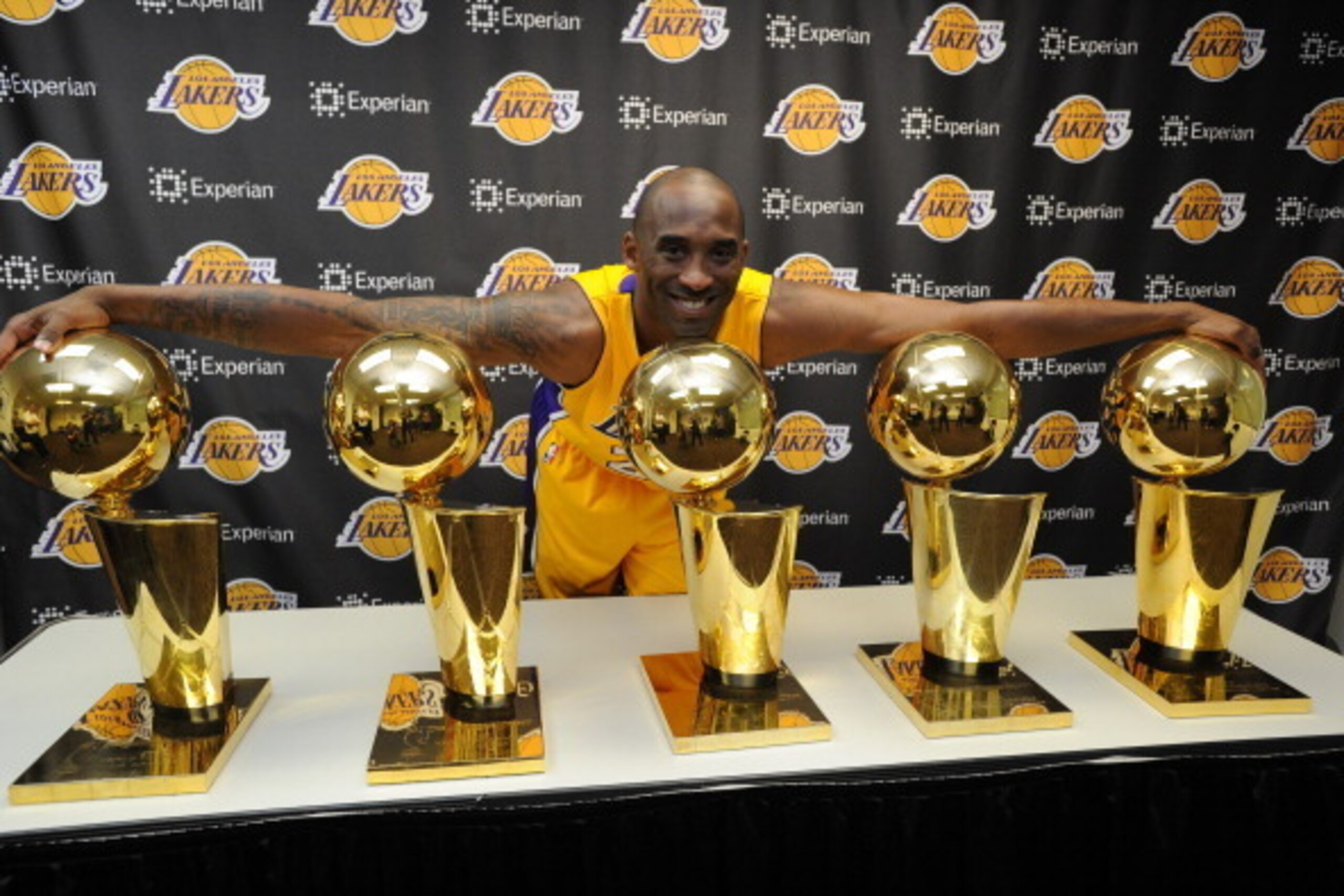 LOS ANGELES, CA - MARCH 20:  Kobe Bryant #24 of the Los Angeles Lakers poses for a picture with his 5 NBA Championship trophies at STAPLES Center on March 20, 2014 in Los Angeles, California. NOTE TO USER: User expressly acknowledges and agrees that, by d