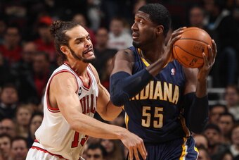 CHICAGO, IL - MARCH 24: Joakim Noah #13 of the Chicago Bulls guards Roy Hibbert #55 of the Indiana Pacers on March 24, 2014 at the United Center in Chicago, Illinois. NOTE TO USER: User expressly acknowledges and agrees that, by downloading and or using t