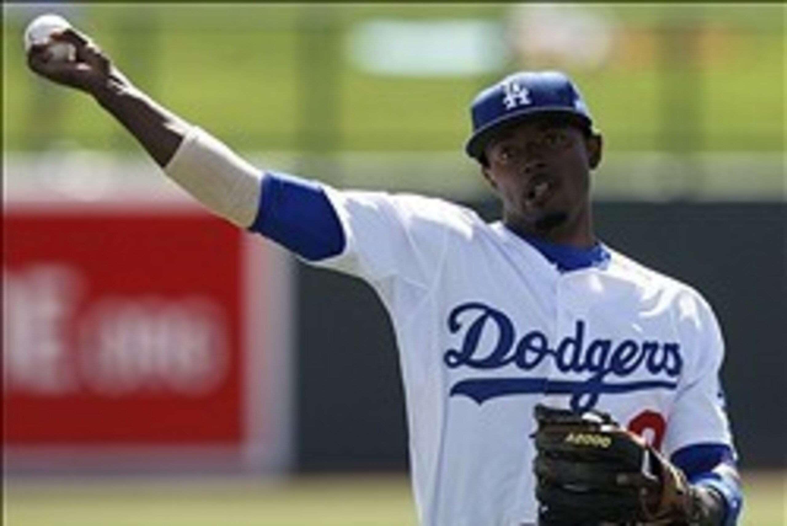 Feb 27, 2014; Phoenix, AZ, USA; Los Angeles Dodgers shortstop Dee Gordon (9) warms up prior to the game against the Arizona Diamondbacks at Camelback Ranch. Mandatory Credit: Rick Scuteri-USA TODAY Sports
