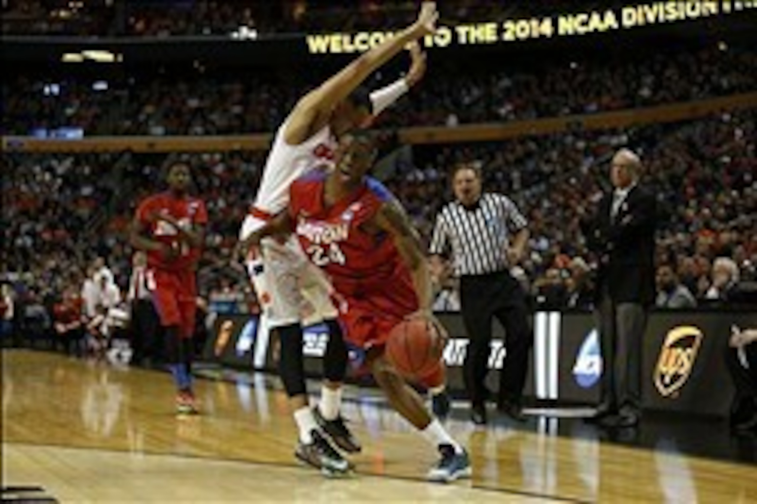 Mar 22, 2014; Buffalo, NY, USA; Dayton Flyers forward Dyshawn Pierre (21) drives to the basket past Syracuse Orange guard Tyler Ennis (11) in the first half of a men's college basketball game during the third round of the 2014 NCAA Tournament at First Nia