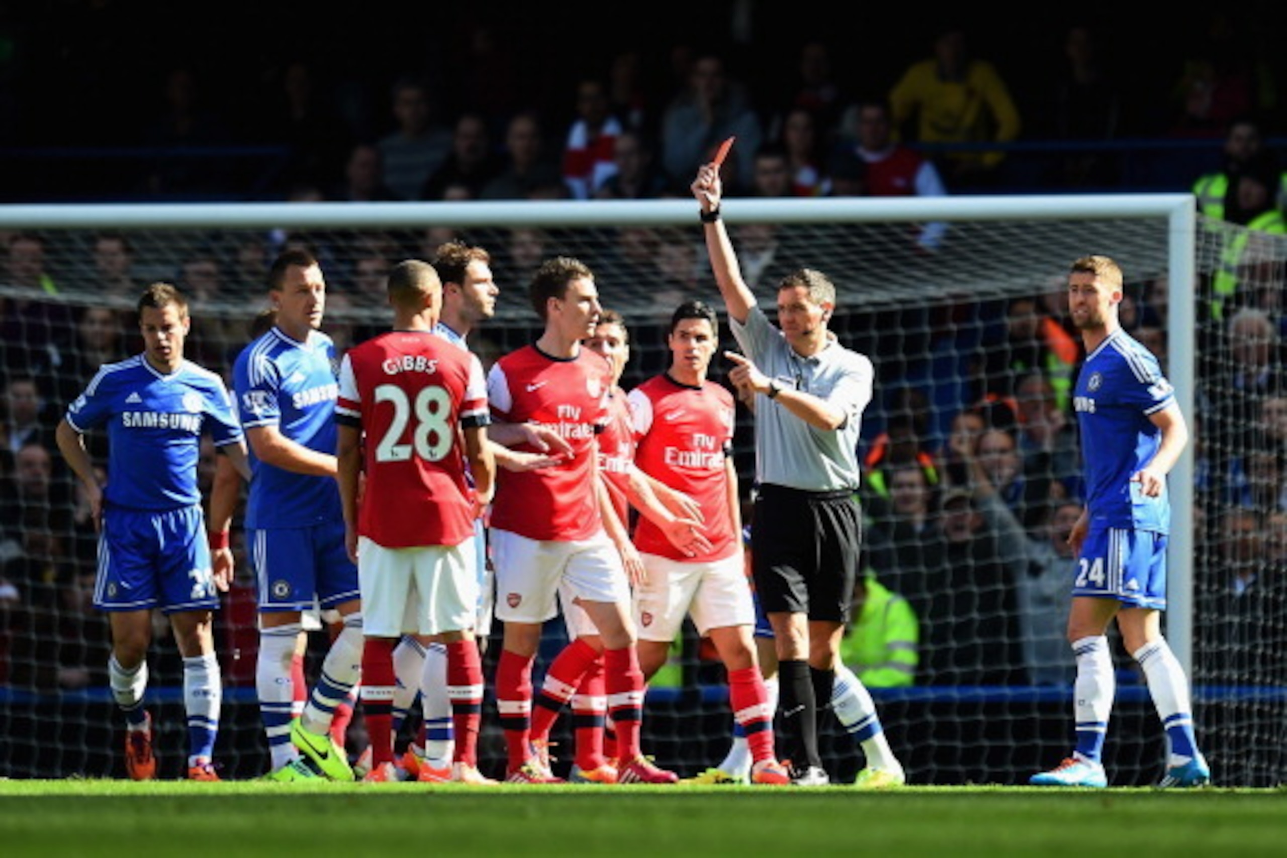 LONDON, ENGLAND - MARCH 22:  Referee Andre Marriner shows Kieran Gibbs of Arsenal a red card during the Barclays Premier League match between Chelsea and Arsenal at Stamford Bridge on March 22, 2014 in London, England.  (Photo by Shaun Botterill/Getty Ima
