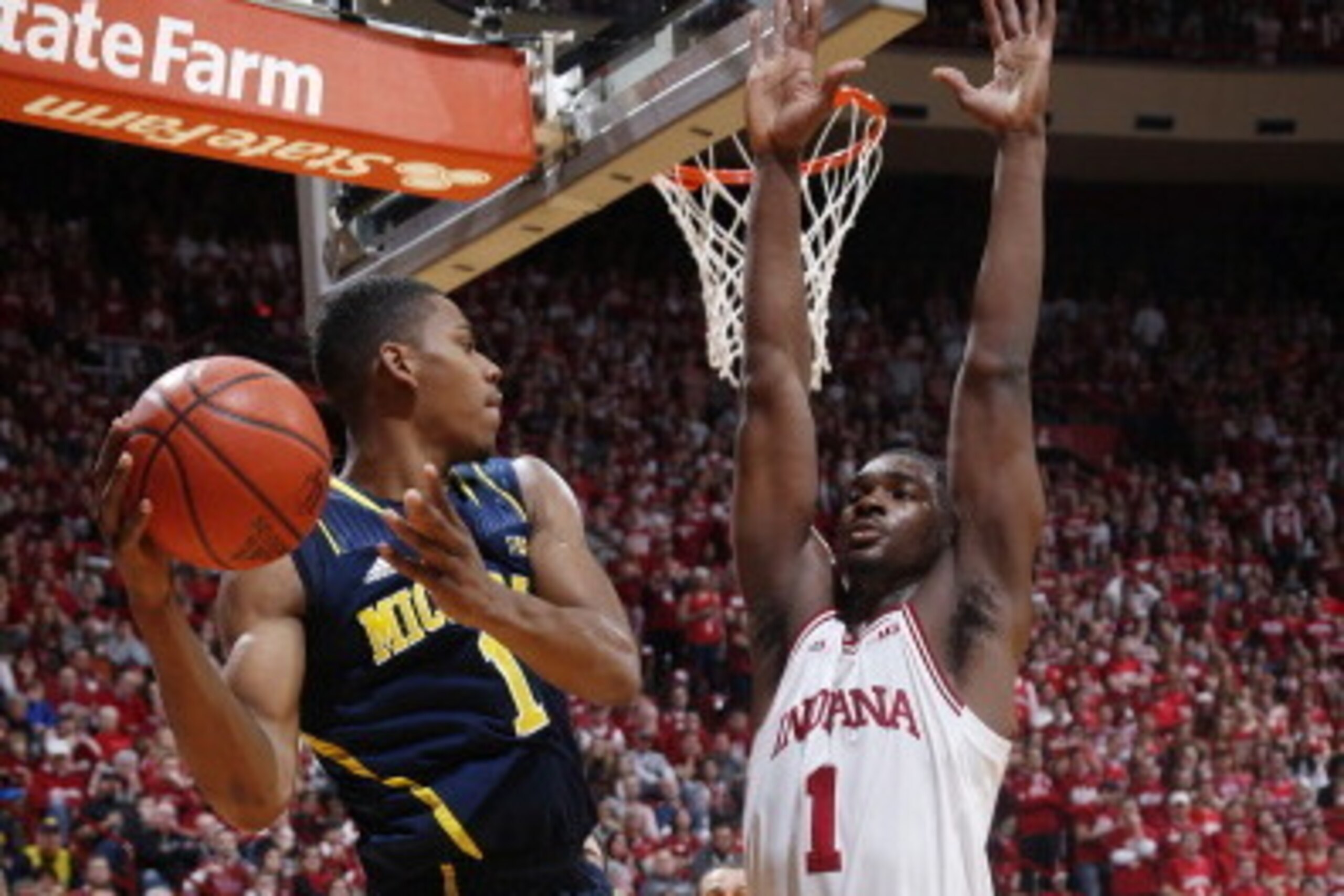 BLOOMINGTON, IN - FEBRUARY 2:  Glenn Robinson III #1 of the Michigan Wolverines looks to pass the ball while defended by Noah Vonleh #1 of the Indiana Hoosiers during the first half of the game at Assembly Hall on February 2, 2014 in Bloomington, Indiana.