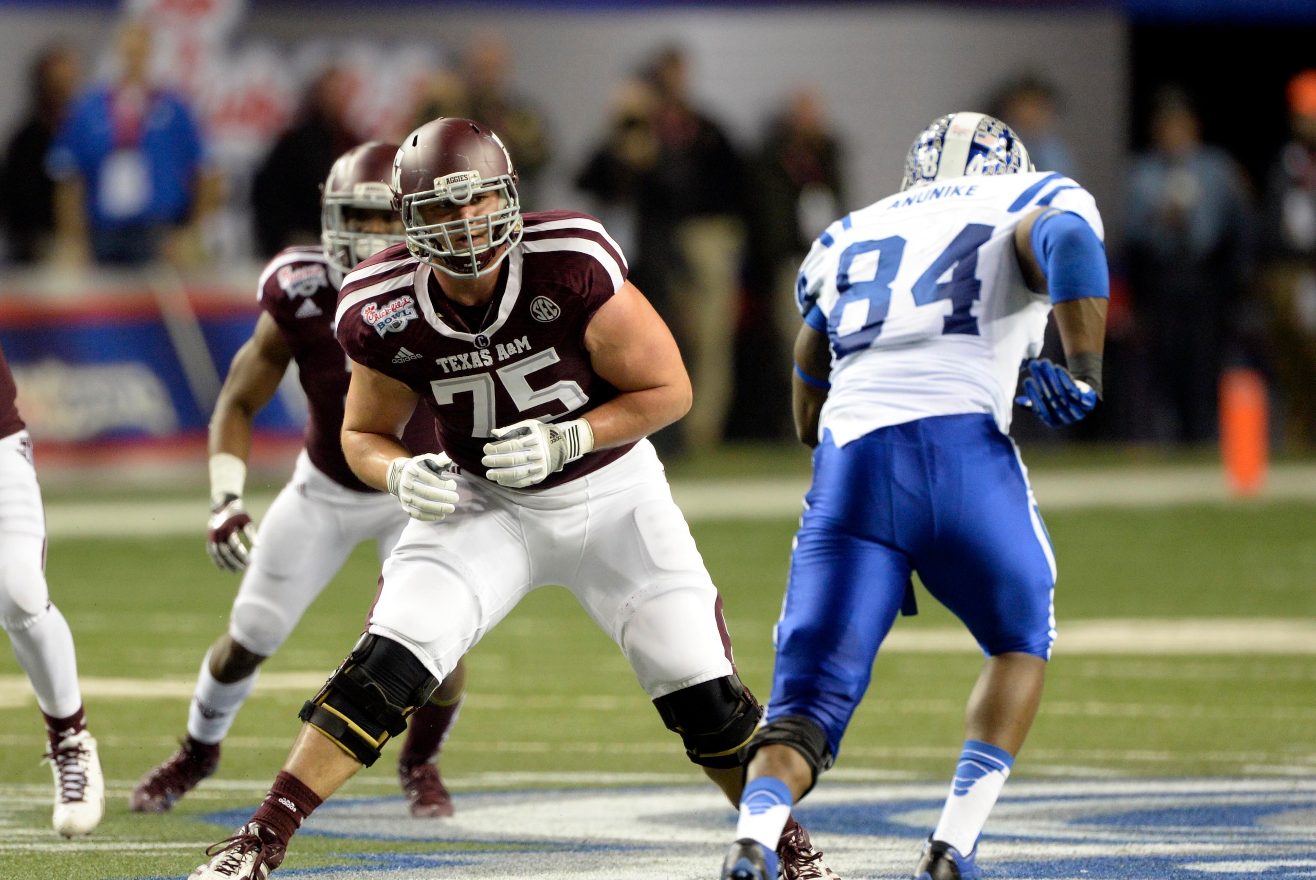 Dec 31, 2013; Atlanta, GA, USA; Texas A&M Aggies offensive linesman Jake Matthews (75) sets to pass block Duke Blue Devils defensive end Kenny Anunike (84) during the second quarter in the 2013 Chick-fil-a Bowl at the Georgia Dome. Mandatory Credit: John