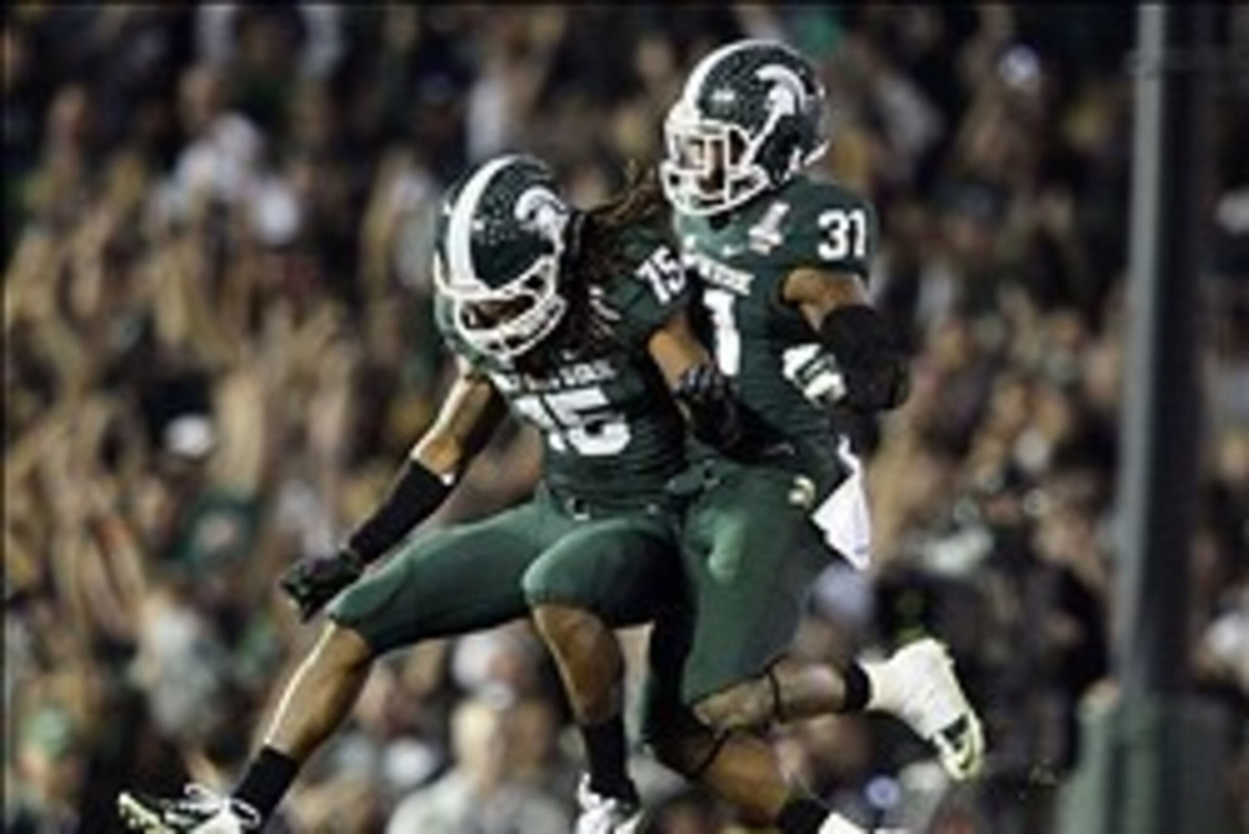 Jan 1, 2014; Pasadena, CA, USA; Michigan State Spartans cornerback Trae Waynes (15) and cornerback Darqueze Dennard (31) celebrate after Michigan State Spartans beat Stanford Cardinal 24-20 at the Rose Bowl. Mandatory Credit: Robert Hanashiro-USA TODAY Sp