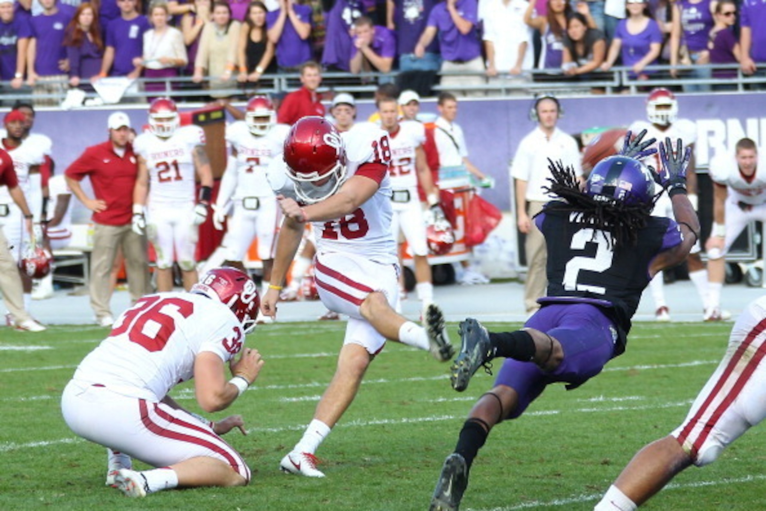 FORT WORTH, TX - DECEMBER 1: Jason Verrett #2 of the TCU Horned Frogs attempts to block Jalen Saunders #18 as he kicks the ball held by Joel Ossom #36 of the Oklahoma Sooners at Amon G. Carter Stadium on December 1, 2012 in Fort Worth, Texas. (Photo by Ri