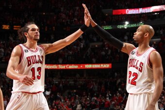 CHICAGO, IL - MAY 04: Joakim Noah #13 and Taj Gibson #22 of the Chicago Bulls congratulate each other against the Atlanta Hawks in Game Two of the Eastern Conference Semifinals during the 2011 NBA Playoffs on May 4, 2011 at the United Center in Chicago, I