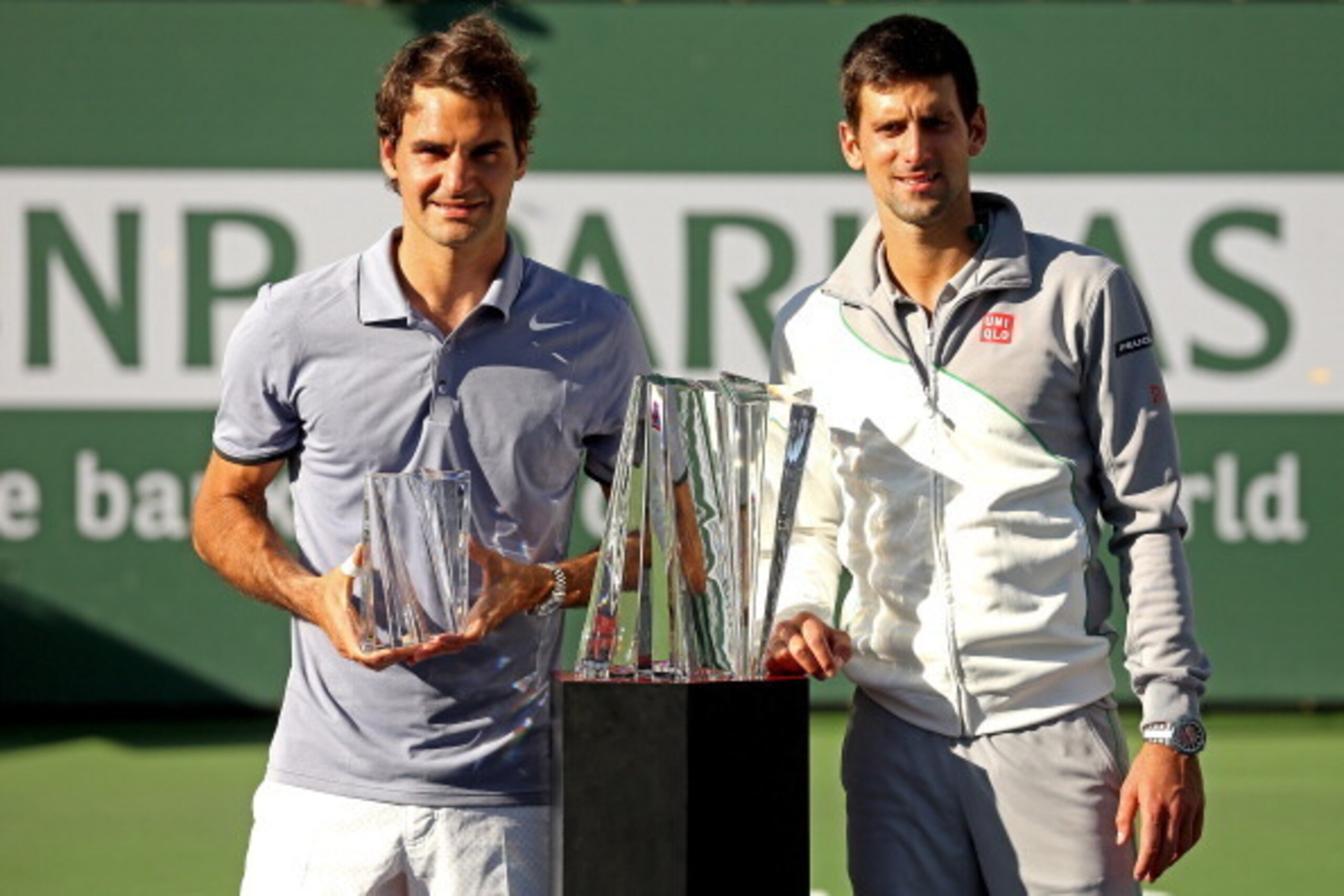 INDIAN WELLS, CA - MARCH 16: Roger Federer of Switzerland and Novak Djokovic of Serbia pose for photographers after their match during the final of the BNP Parabas Open at the Indian Wells Tennis Garden on March 16, 2014 in Indian Wells, California.  (Pho