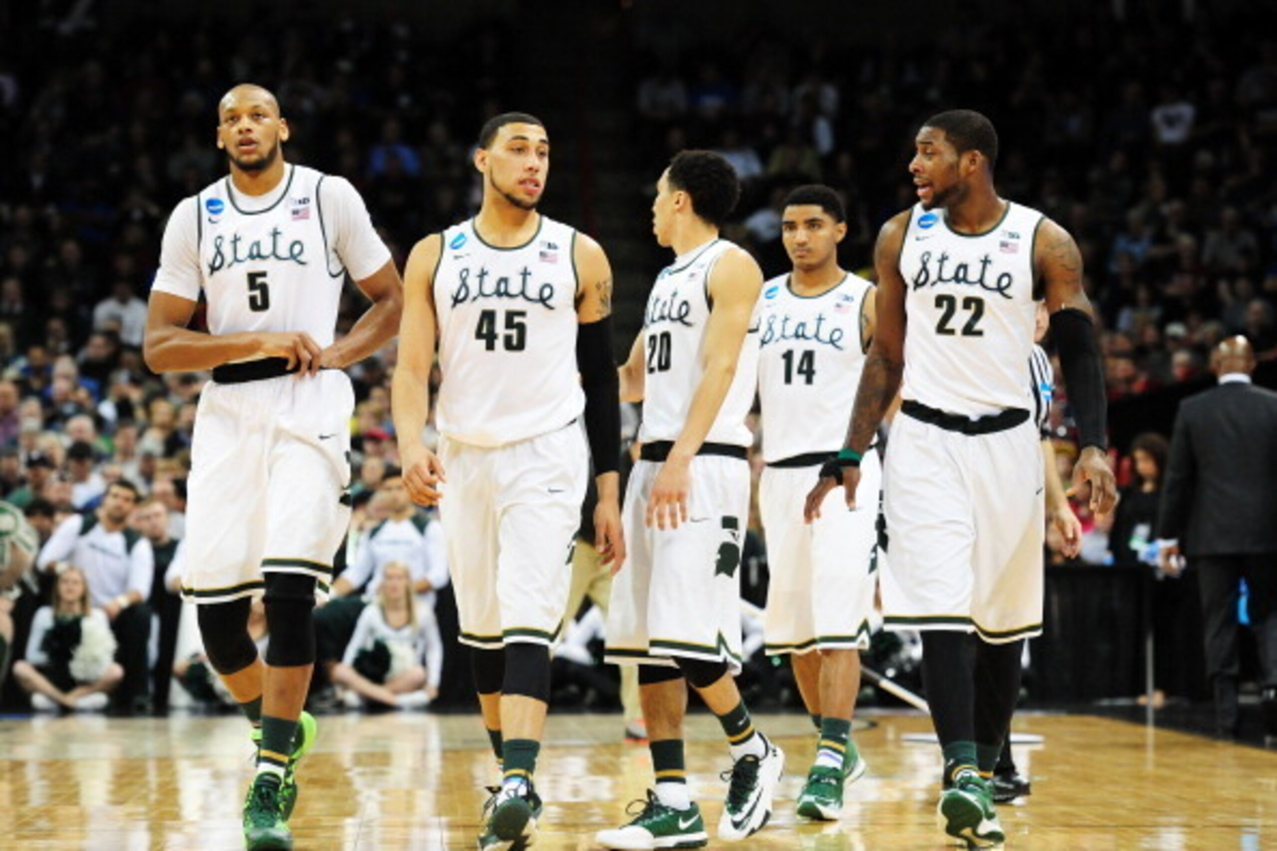 SPOKANE, WA - MARCH 22: Adreian Payne #5 Denzel Valentine #45 Travis Trice #20 Gary Harris #14 and Branden Dawson #22 of the Michigan State Spartans look on against the Harvard Crimson in the second half during the Third Round of the 2014 NCAA Basketball SPOKANE, WA - MARCH 22: Adreian Payne #5 Denzel Valentine #45 Travis Trice #20 Gary Harris #14 and Branden Dawson #22 of the Michigan State Spartans look on against the Harvard Crimson in the second half during the Third Round of the 2014 NCAA Basketball