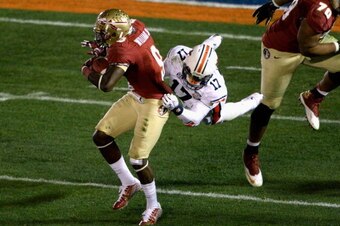 PASADENA, CA - JANUARY 06:  Running back Karlos Williams #9 of the Florida State Seminoles is tackled by linebacker Kris Frost #17 of the Auburn Tigers in the third quarterof the 2014 Vizio BCS National Championship Game at the Rose Bowl on January 6, 201