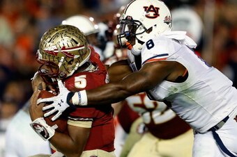 PASADENA, CA - JANUARY 06:  Quarterback Jameis Winston #5 of the Florida State Seminoles is sacked by linebacker Cassanova McKinzy #8 of the Auburn Tigers in the third quarter of the 2014 Vizio BCS National Championship Game at the Rose Bowl on January 6,