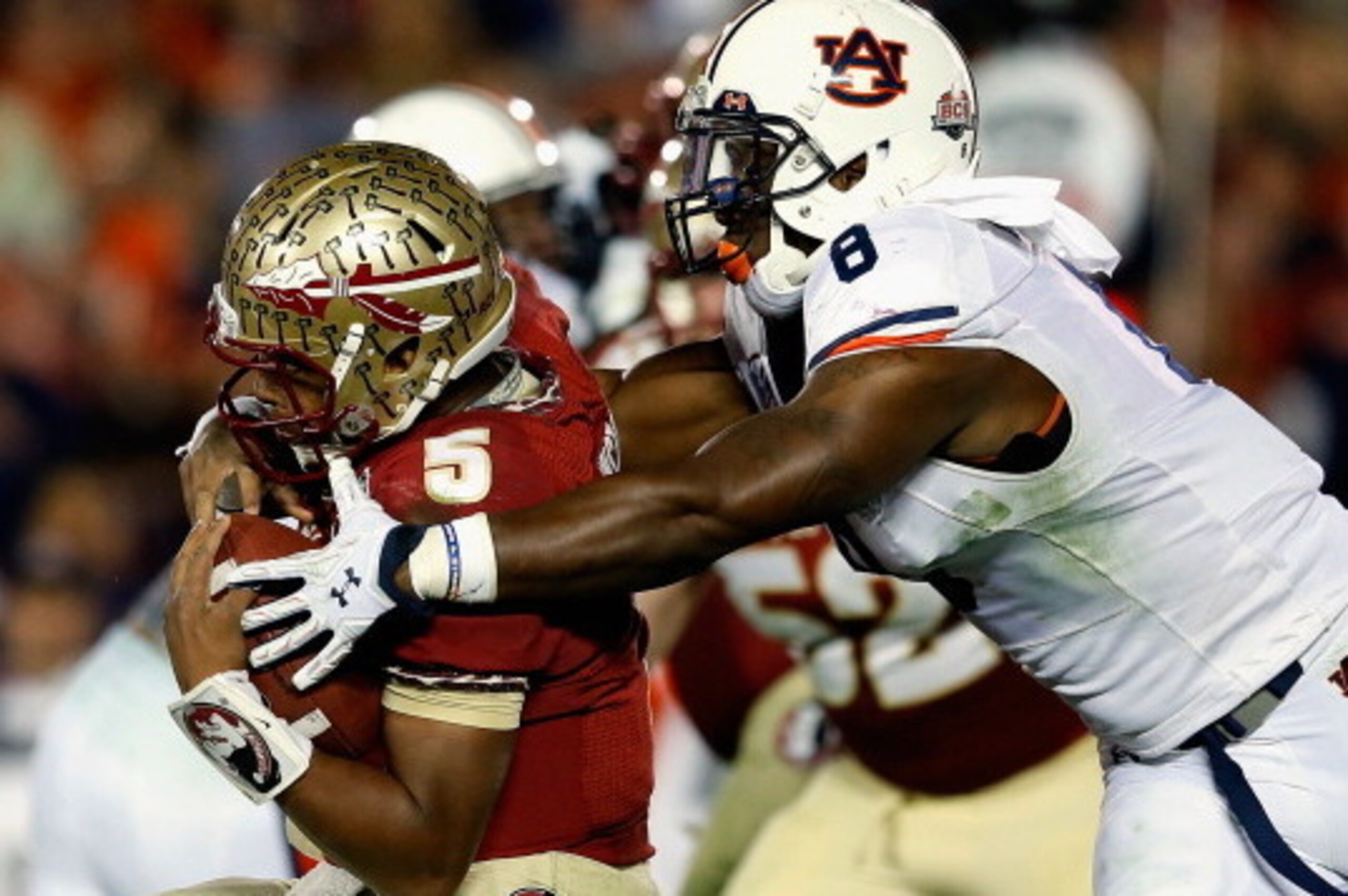PASADENA, CA - JANUARY 06:  Quarterback Jameis Winston #5 of the Florida State Seminoles is sacked by linebacker Cassanova McKinzy #8 of the Auburn Tigers in the third quarter of the 2014 Vizio BCS National Championship Game at the Rose Bowl on January 6,