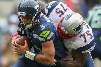 SEATTLE, WA - OCTOBER 14:  Quarterback Russell Wilson #3 of the Seattle Seahawks is tackled by defensive tackle Vince Wilfork #75 of the New England Patriots at CenturyLink Field on October 14, 2012 in Seattle, Washington.  (Photo by Otto Greule Jr/Getty 