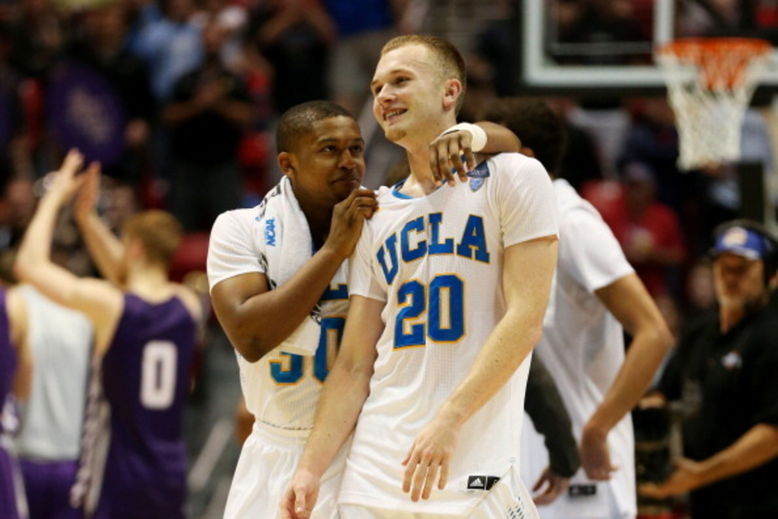 SAN DIEGO, CA - MARCH 23:  Aubrey Williams #30 and Bryce Alford #20 of the UCLA Bruins celebrate their 77 to 60 win over the Stephen F. Austin Lumberjacks during the third round of the 2014 NCAA Men's Basketball Tournament at Viejas Arena on March 23, 201