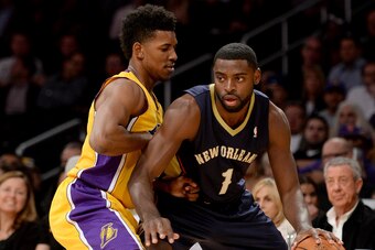 LOS ANGELES, CA - NOVEMBER 12:  Tyreke Evans #1 of the New Orleans Pelicans is guarded by Nick Young #0 of the Los Angeles Lakers at Staples Center on November 12, 2013 in Los Angeles, California.  NOTE TO USER: User expressly acknowledges and agrees that
