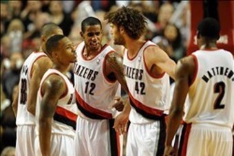 Dec 2, 2013; Portland, OR, USA; Portland Trail Blazers power forward LaMarcus Aldridge (12) speaks with small forward Nicolas Batum (88), point guard Damian Lillard (0), center Robin Lopez (42) and shooting guard Wesley Matthews (2) during the fourth quar