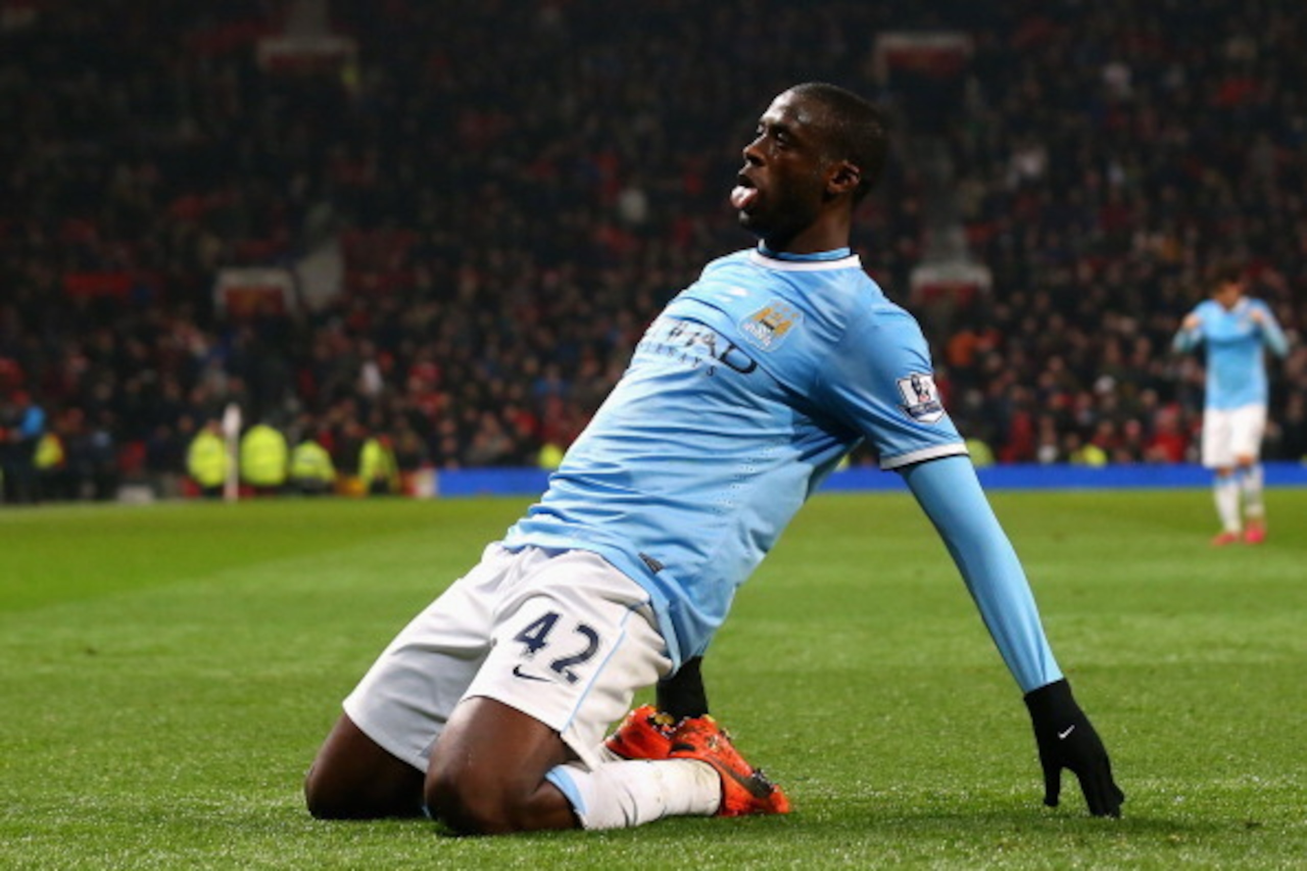 MANCHESTER, ENGLAND - MARCH 25:  Yaya Toure of Manchester City celebrates scoring the third goal during the Barclays Premier League match between Manchester United and Manchester City at Old Trafford on March 25, 2014 in Manchester, England.  (Photo by Al