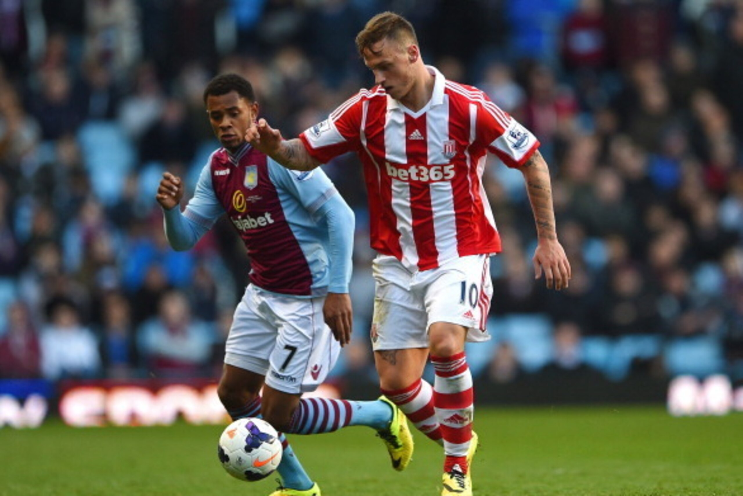 BIRMINGHAM, ENGLAND - MARCH 23:  Marko Arnautovic of Stoke is pursued by Leandro Bacuna of Aston Villa during the Barclays Premier League match between Aston Villa and Stoke City at Villa Park on March 23, 2014 in Birmingham, England.  (Photo by Michael R