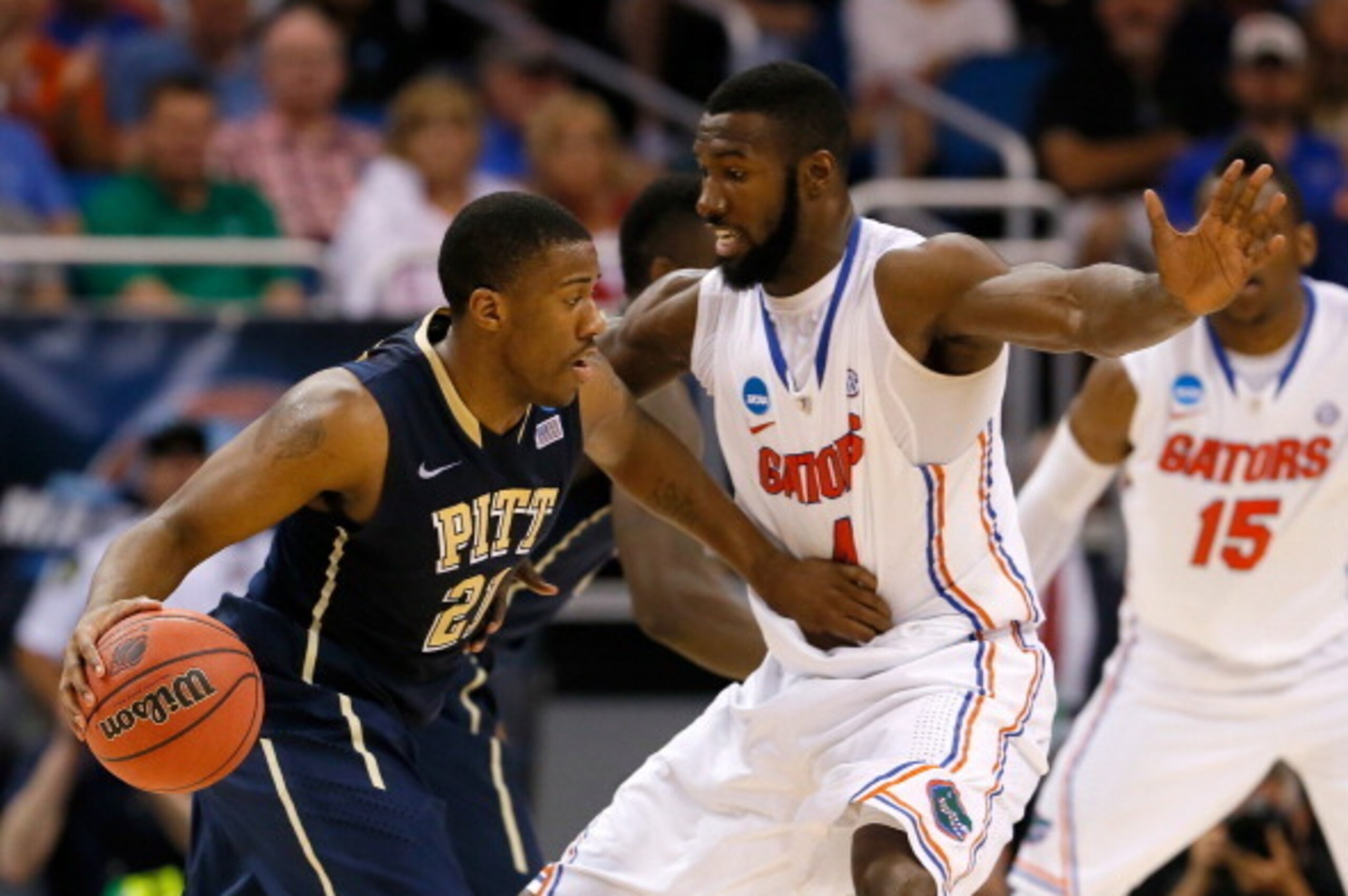 ORLANDO, FL - MARCH 22:  Lamar Patterson #21 of the Pittsburgh Panthers looks to drive against Patric Young #4 of the Florida Gators in the second half during the third round of the 2014 NCAA Men's Basketball Tournament at Amway Center on March 22, 2014 i