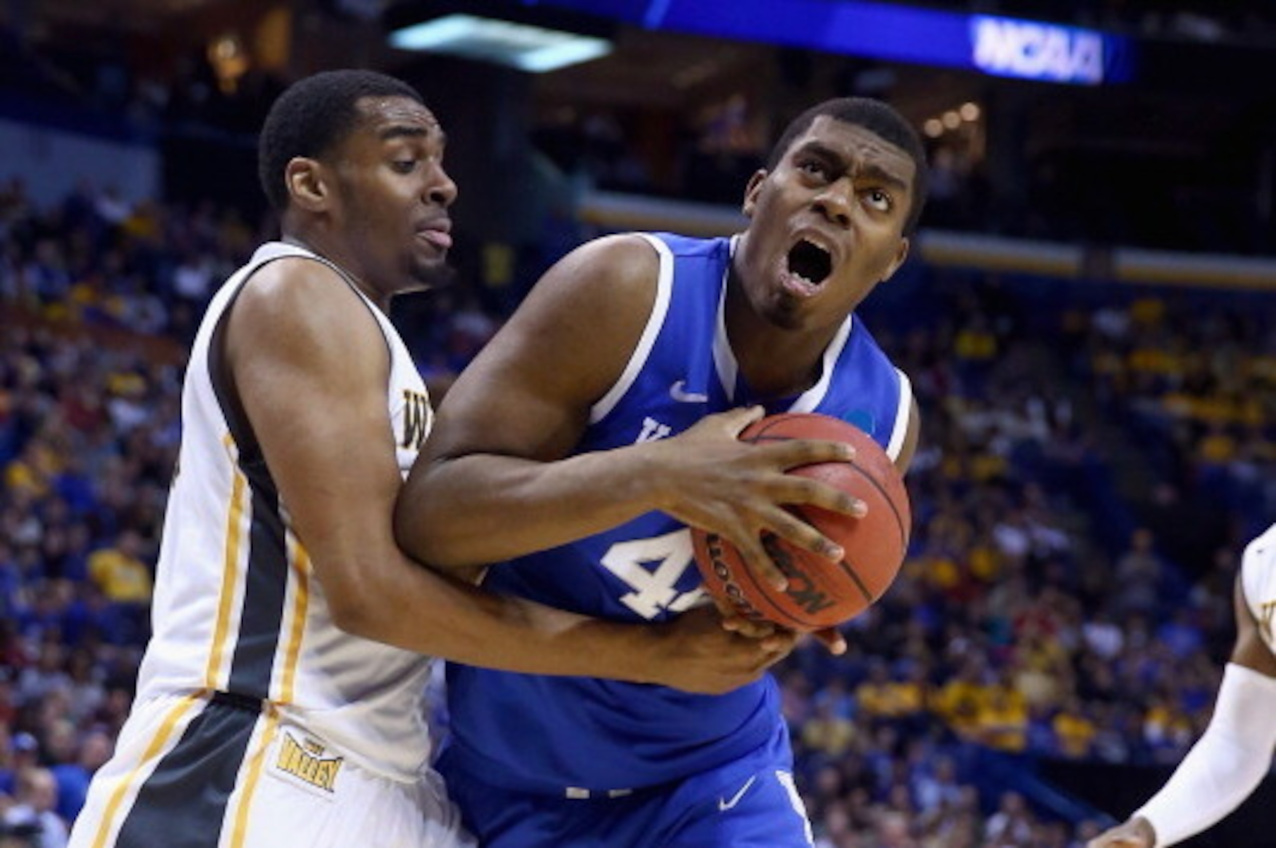 ST LOUIS, MO - MARCH 23:  Dakari Johnson #44 of the Kentucky Wildcats drives to the basket against Darius Carter #12 of the Wichita State Shockers during the third round of the 2014 NCAA Men's Basketball Tournament at Scottrade Center on March 23, 2014 in