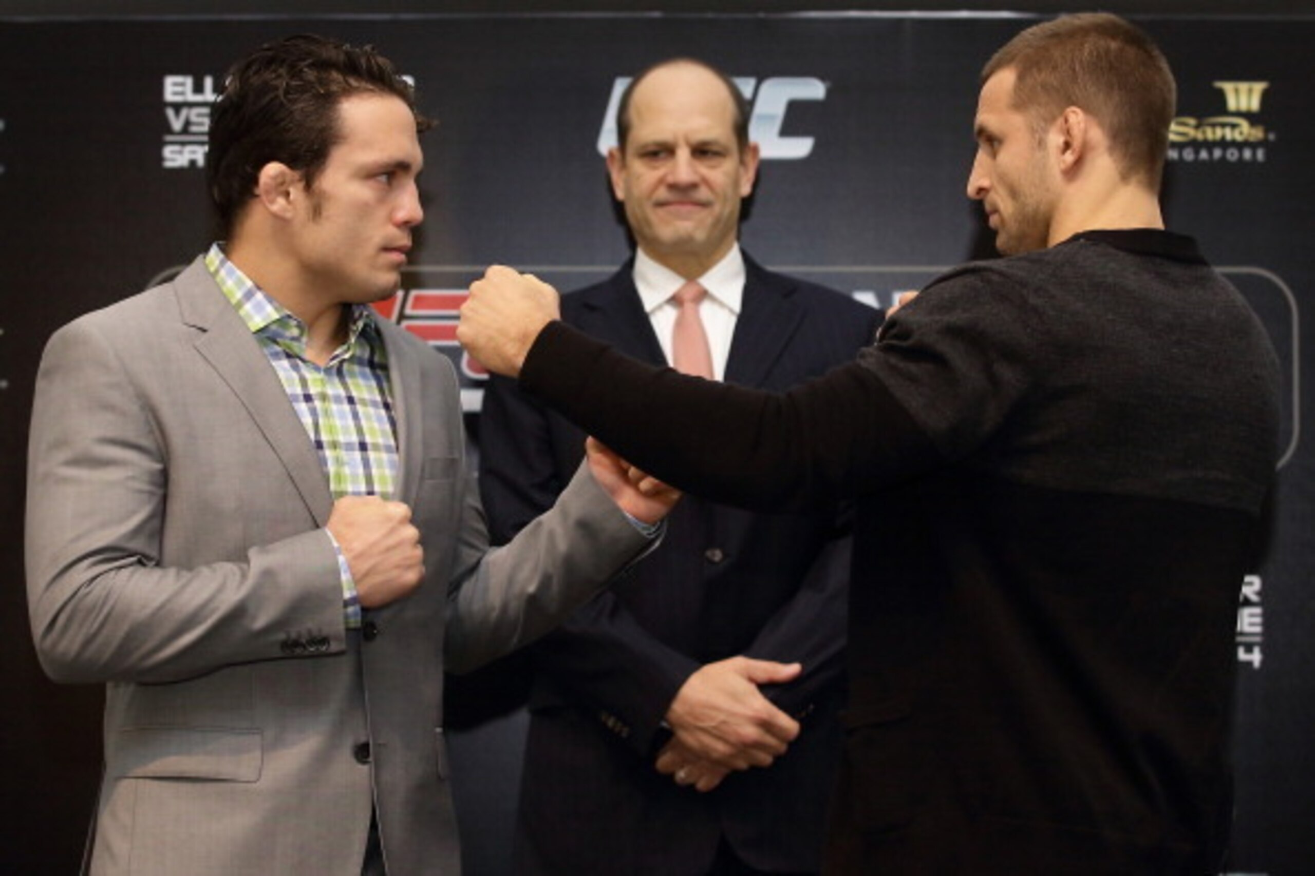 SINGAPORE - NOVEMBER 06: Jake 'The Juggernaugh' Ellenberger (L) and Tarec 'Sponge' Saffiedine (R) face off as Mark Fischer, Managing Director of UFC Asia looks on during the Ultimate Fighting Championship (UFC) press conference at Marina Bay Sands on Nov SINGAPORE - NOVEMBER 06: Jake 'The Juggernaugh' Ellenberger (L) and Tarec 'Sponge' Saffiedine (R) face off as Mark Fischer, Managing Director of UFC Asia looks on during the Ultimate Fighting Championship (UFC) press conference at Marina Bay Sands on Nov