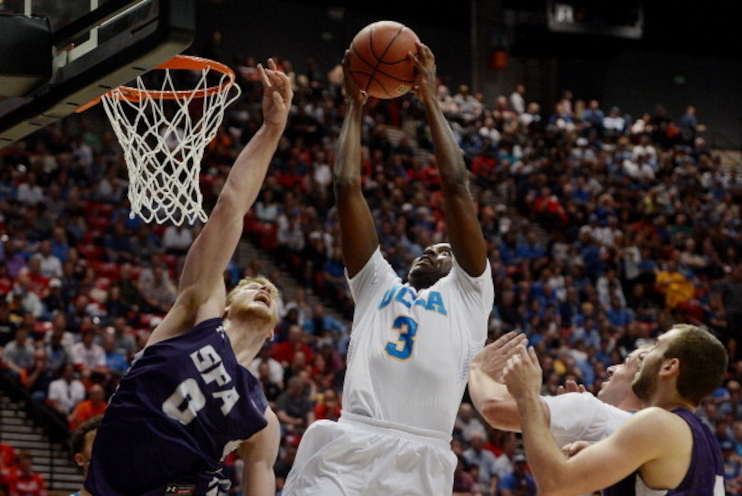 SAN DIEGO, CA - MARCH 23:  Jordan Adams #3 of the UCLA Bruins shoots over Thomas Walkup #0 of the Stephen F. Austin Lumberjacks in the second half during the third round of the 2014 NCAA Men's Basketball Tournament at Viejas Arena on March 23, 2014 in San