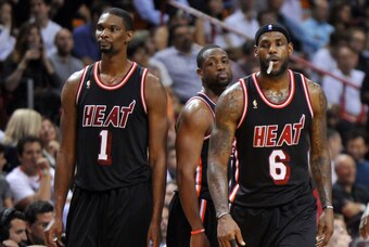 Jan 29, 2014; Miami, FL, USA; Miami Heat center Chris Bosh (left) shooting guard Dwyane Wade (center) and small forward LeBron James (right) react after a timeout after the Oklahoma City Thunder during the second half at American Airlines Arena. Mandatory
