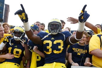 ANN ARBOR, MI - AUGUST 31: Taco Charlton #33 of the Michigan Wolverines and Blake Countess #18 celebrates a 59-9 win over the Central Michigan Chippewas at Michigan Stadium on August 31, 2013 in Ann Arbor, Michigan.  (Photo by Gregory Shamus/Getty Images)