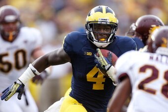 ANN ARBOR, MI - AUGUST 31: De'Veon Smith #4 of the Michigan Wolverines looks for extra yards during a fourth quarter run while playing the Central Michigan Chippewas at Michigan Stadium on August 31, 2013 in Ann Arbor, Michigan. Michigan won the 59-9. (Ph