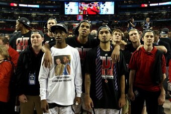 ATLANTA, GA - APRIL 08:  (L-R) Russ Smith #2 (wearing white shirt), Chane Behanan #21 and Peyton Siva #3 of the Louisville Cardinals look on after they won 82-76 against the Michigan Wolverines during the 2013 NCAA Men's Final Four Championship at the Geo