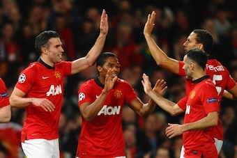 MANCHESTER, ENGLAND - MARCH 19:  Robin van Persie of Manchester United celebrates scoring the second goal with his team-mates during the UEFA Champions League Round of 16 second round match between Manchester United and Olympiacos FC at Old Trafford on Ma