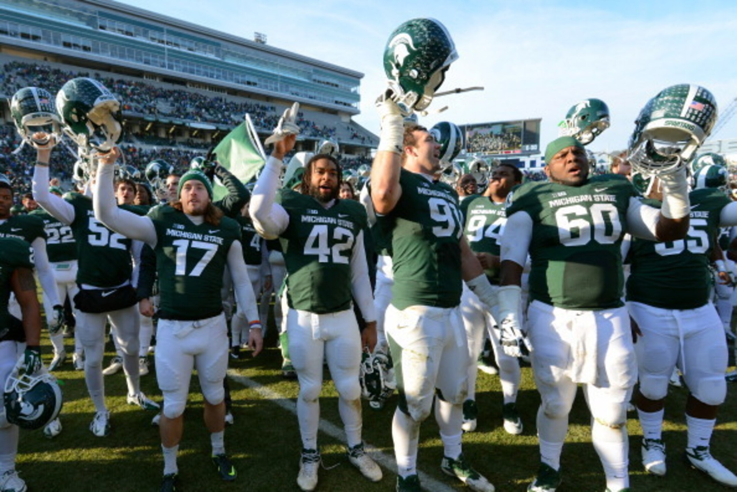 EAST LANSING, MI - NOVEMBER 30:  Michigan State Spartans players celebrate the victory against the Minnesota Golden Gophers at Spartan Stadium on November 30, 2013 in East Lansing, Michigan. The Spartans defeated the Golden Gophers 14-3.  (Photo by Mark A
