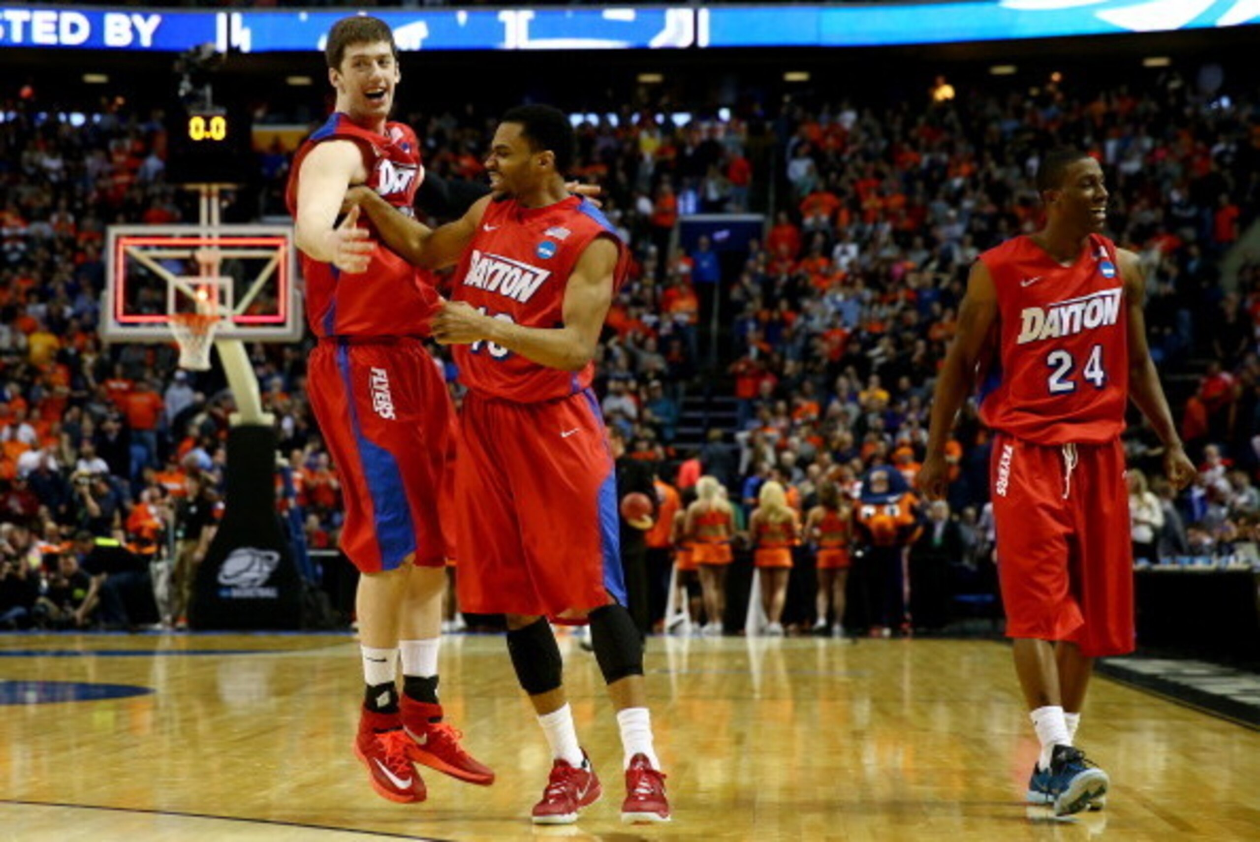 BUFFALO, NY - MARCH 22: Matt Kavanaugh #35,Vee Sanford #43, and Jordan Sibert #24 of the Dayton Flyers celebrate after defeating the Syracuse Orange 55-53 in the third round of the 2014 NCAA Men's Basketball Tournament at the First Niagara Center on March